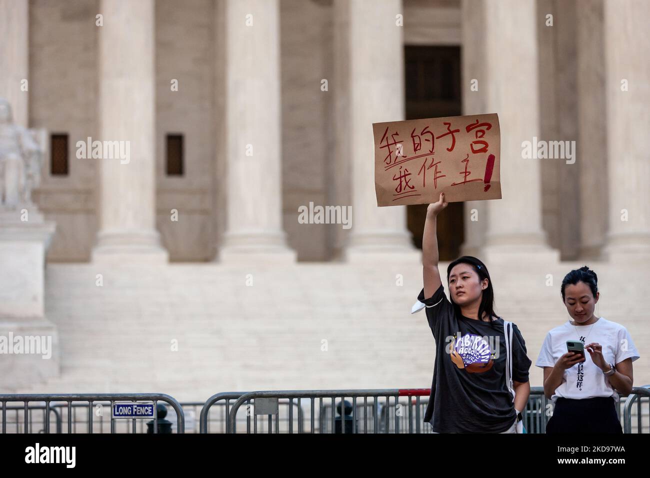 Zhangzhu, a stundet at George Washington University, holds a sign in Chinese that translates as 'my uterus, my choice' in front of the Supreme Court.The rally was prompted by a report that the justices voted to overturn Roe v. Wade in a draft opinion for the Dobbs v. JWHO case. Jackson Women’s Health Organization is challenging Mississippi’s ban on abortion after 15 weeks, prior to fetal viability, which has been the standard since the Roe decision. (Photo by Allison Bailey/NurPhoto) Stock Photo