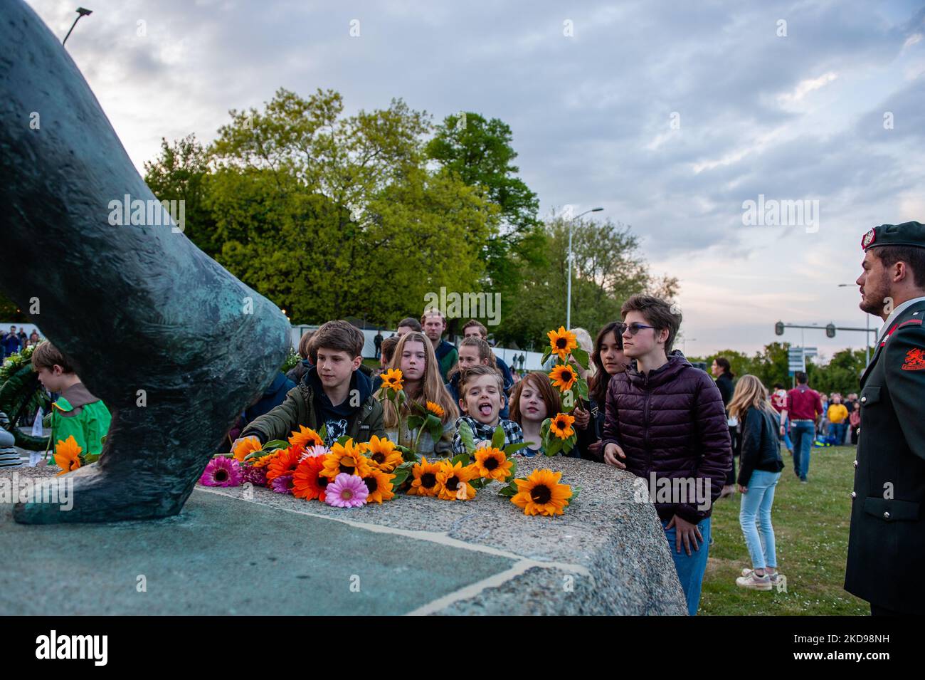 Children are leaving flowers at the 'Keizer Traianusplein', where two monuments in remember of the victims of WWII stand up, during the Remembrance Day held again in Nijmegen, on May 4th, 2022. (Photo by Romy Arroyo Fernandez/NurPhoto) Stock Photo