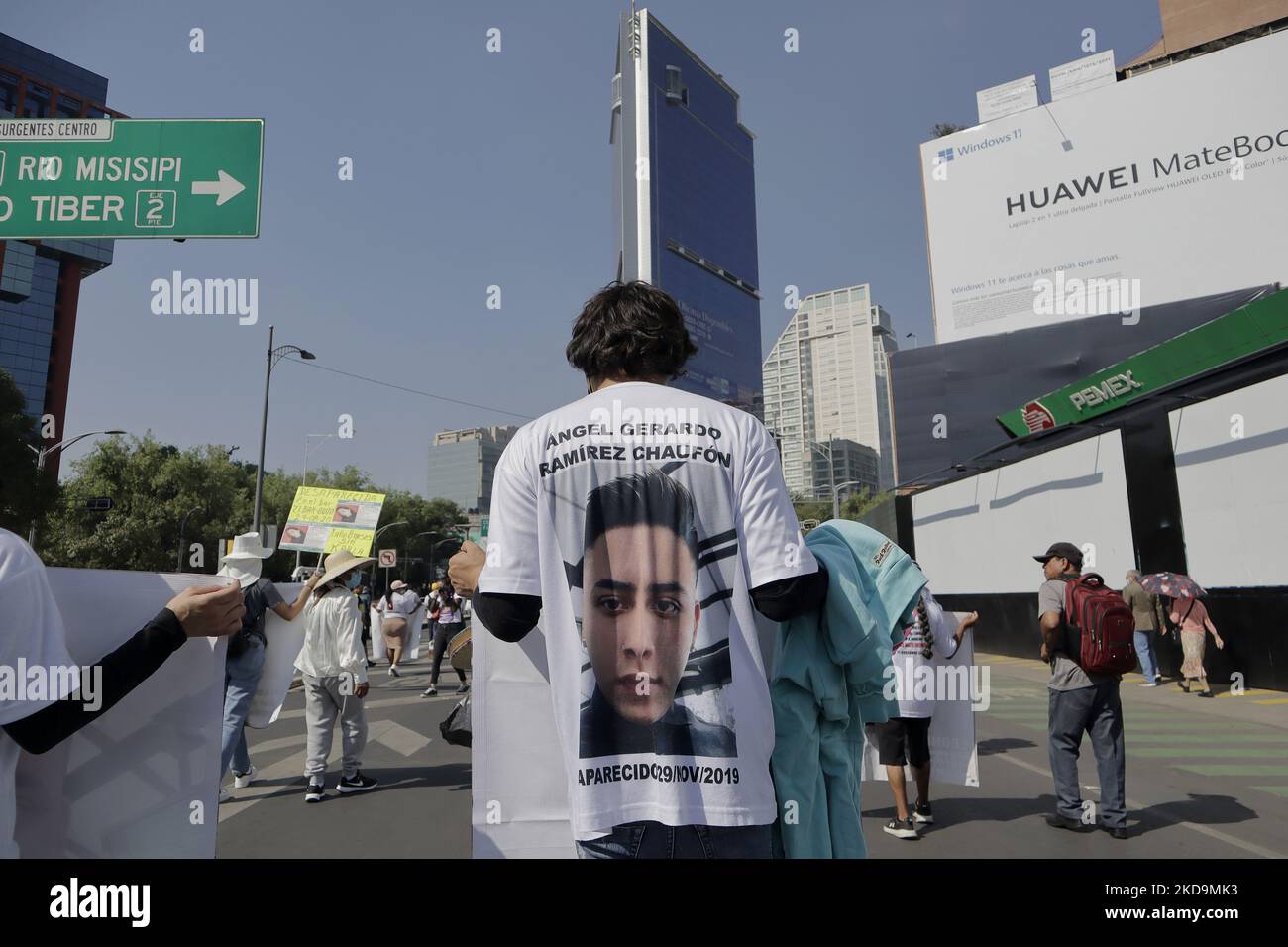 A member of the Caravan of Central American and Mexican Mothers and Fathers wears a T-shirt with a photograph on the back as she marches on Paseo de la Reforma to the Angel of Independence in Mexico City, to mark Mothers' Day in Mexico, to demand the appearance of their disappeared relatives. (Photo by Gerardo Vieyra/NurPhoto) Stock Photo