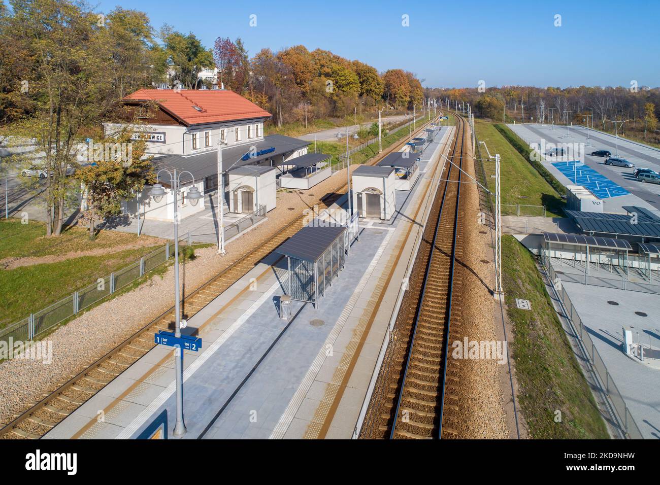Newly modernized small railway station in Swoszowice district in Krakow, Poland, for fast city trains and regional passengers transportation. Big park Stock Photo