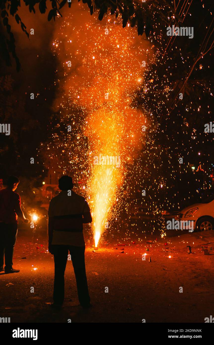 A vertical shot of crackers burning in the street on Diwali night for celebrating the festival in India Stock Photo
