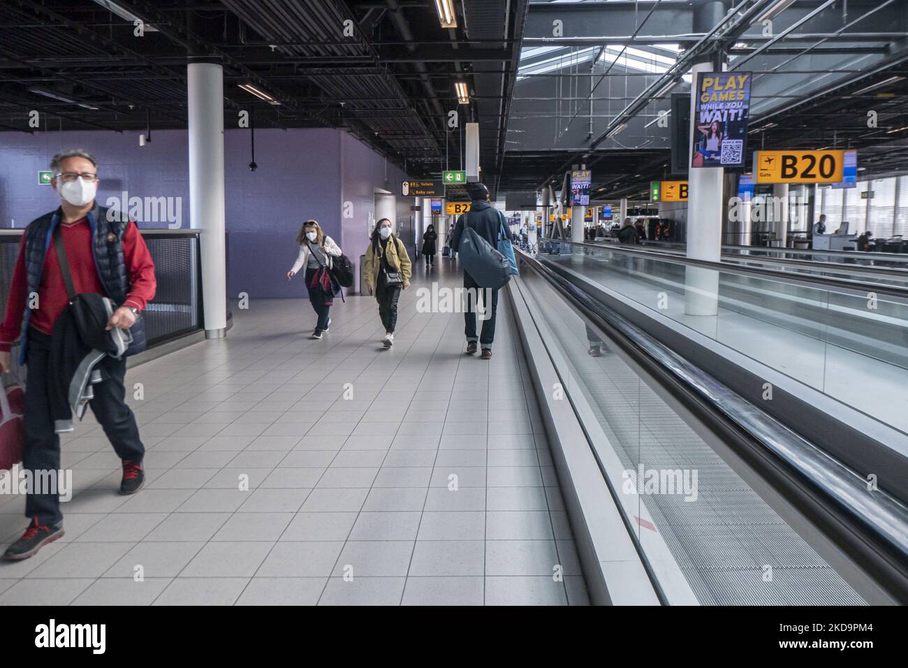 Passengers as seen wearing face masks inside the terminal, the