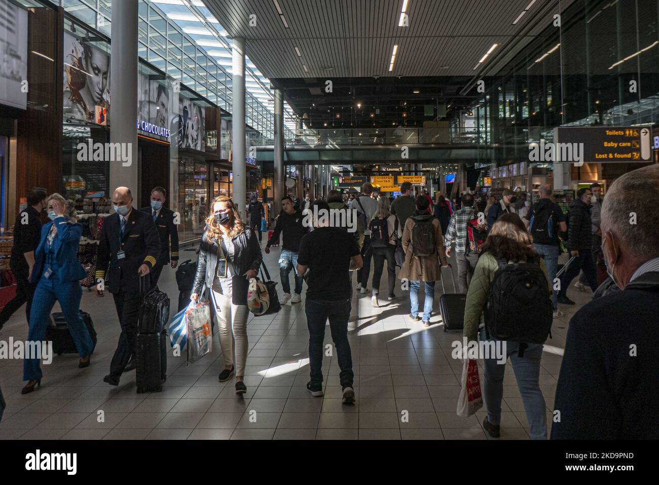 Passengers as seen wearing face masks inside the terminal, the