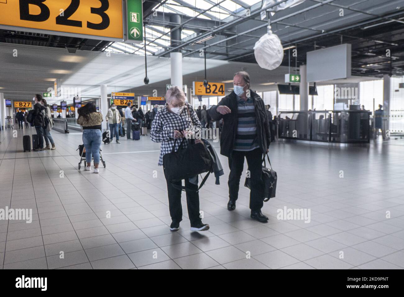 Passengers as seen wearing face masks inside the terminal, the