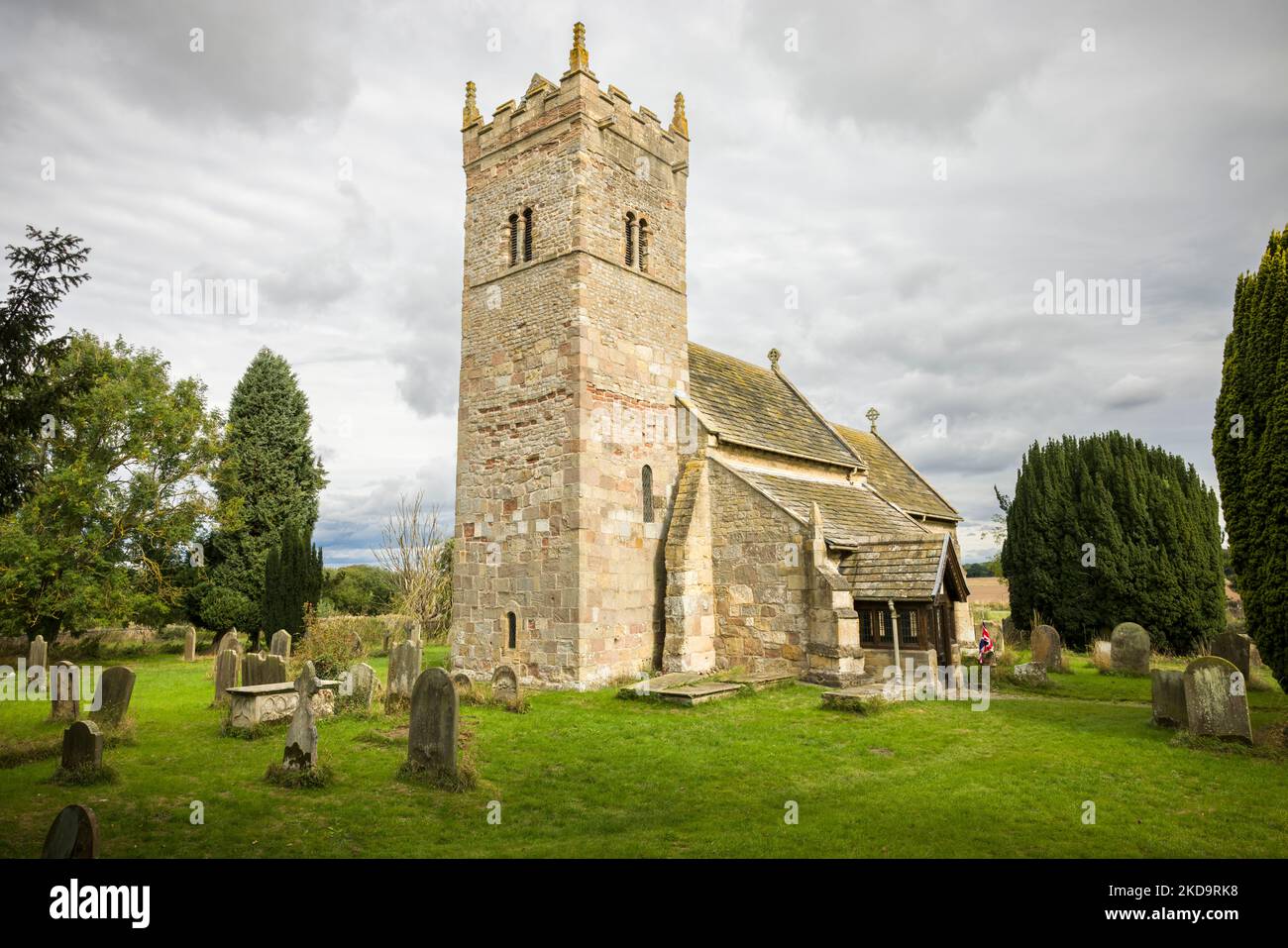 Church exterior, Holy Trinity Norman church in Little Ouseburn, Yorkshire, UK Stock Photo