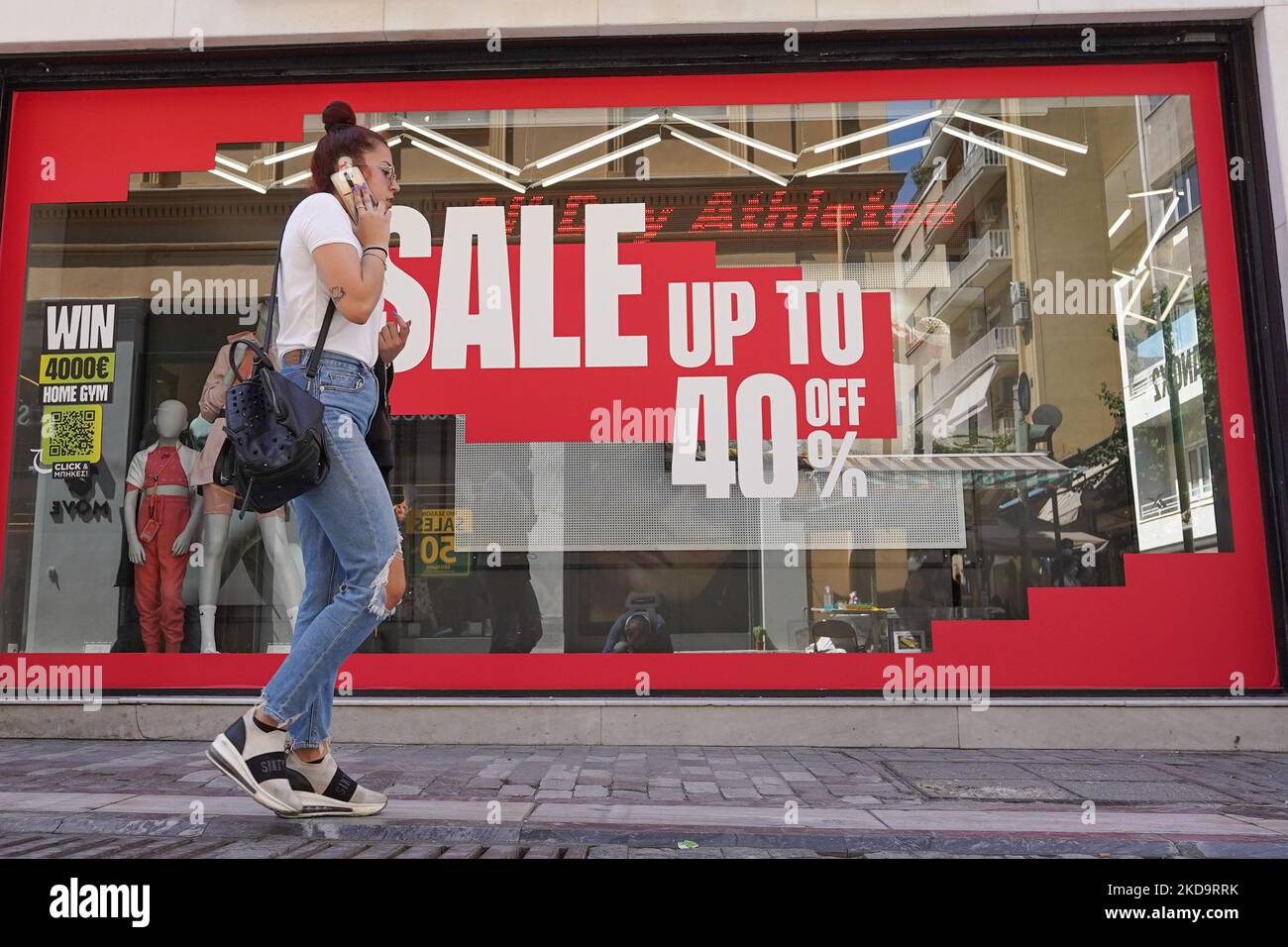 A woman walks past a shop in Athens on 12 May 2022. (Photo by Giannis Alexopoulos/NurPhoto) Stock Photo