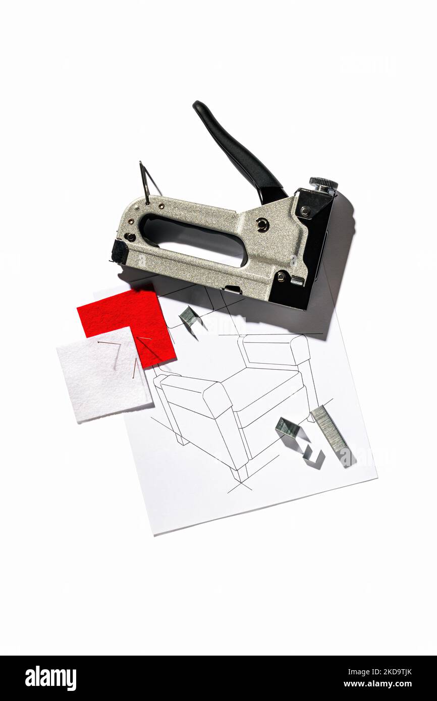 Silver furniture stapler gun with staples and the drawing of the