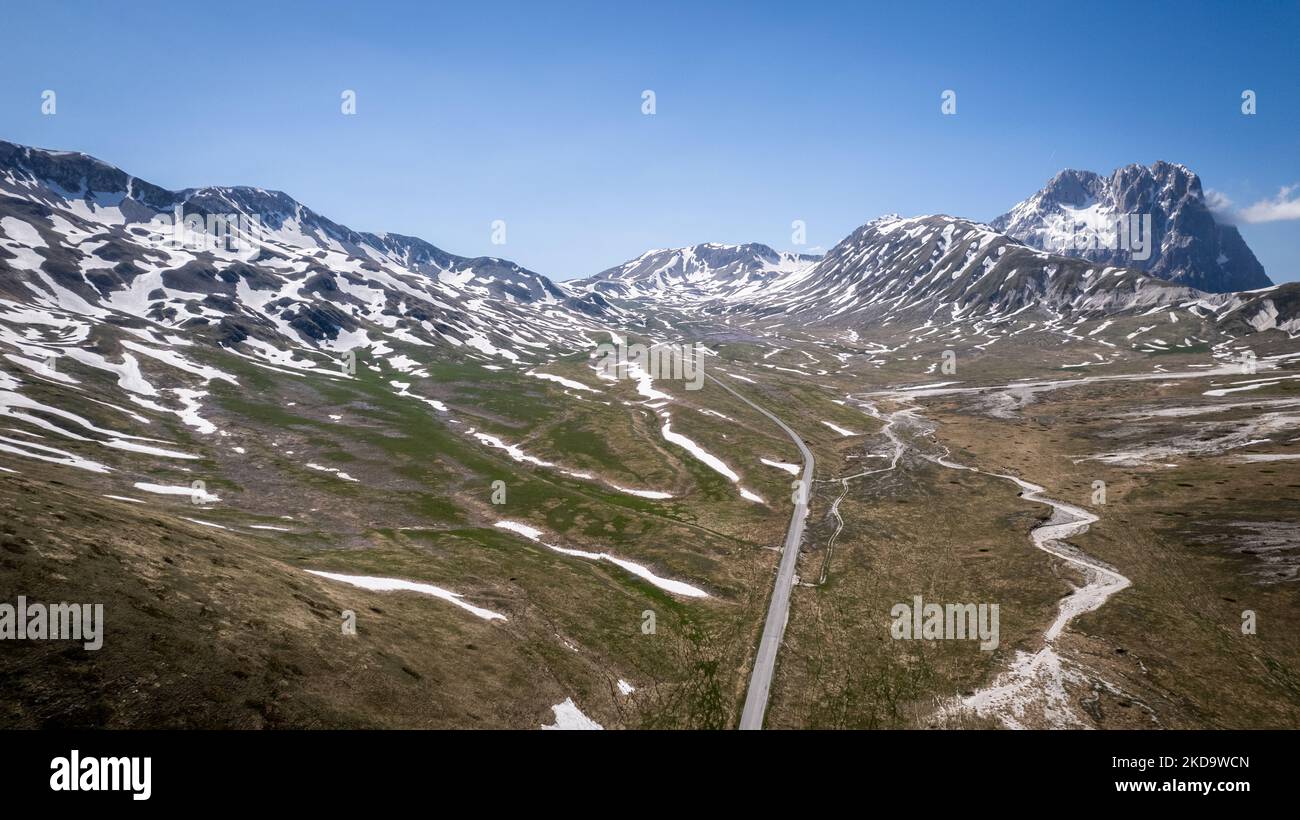 A drone view of the Campo Imperatore (in the background the Gran Sasso mountain) in the Gran Sasso and Laga Mountains National Park, on May 13, 2022. -Gran Sasso d'Italia is a massif in the Apennine Mountains of Italy. Its highest peak, Corno Grande (2,912 metres), is the highest mountain in the Apennines, and the second-highest mountain in Italy outside the Alps. (Photo by Manuel Romano/NurPhoto) Stock Photo