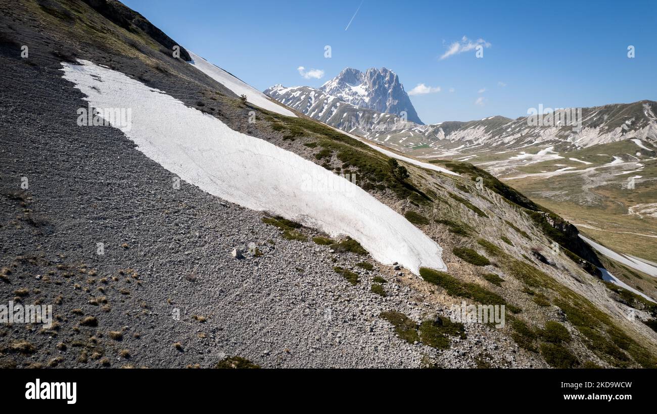A drone view of the Campo Imperatore (in the background the Gran Sasso mountain) in the Gran Sasso and Laga Mountains National Park, on May 13, 2022. -Gran Sasso d'Italia is a massif in the Apennine Mountains of Italy. Its highest peak, Corno Grande (2,912 metres), is the highest mountain in the Apennines, and the second-highest mountain in Italy outside the Alps. (Photo by Manuel Romano/NurPhoto) Stock Photo