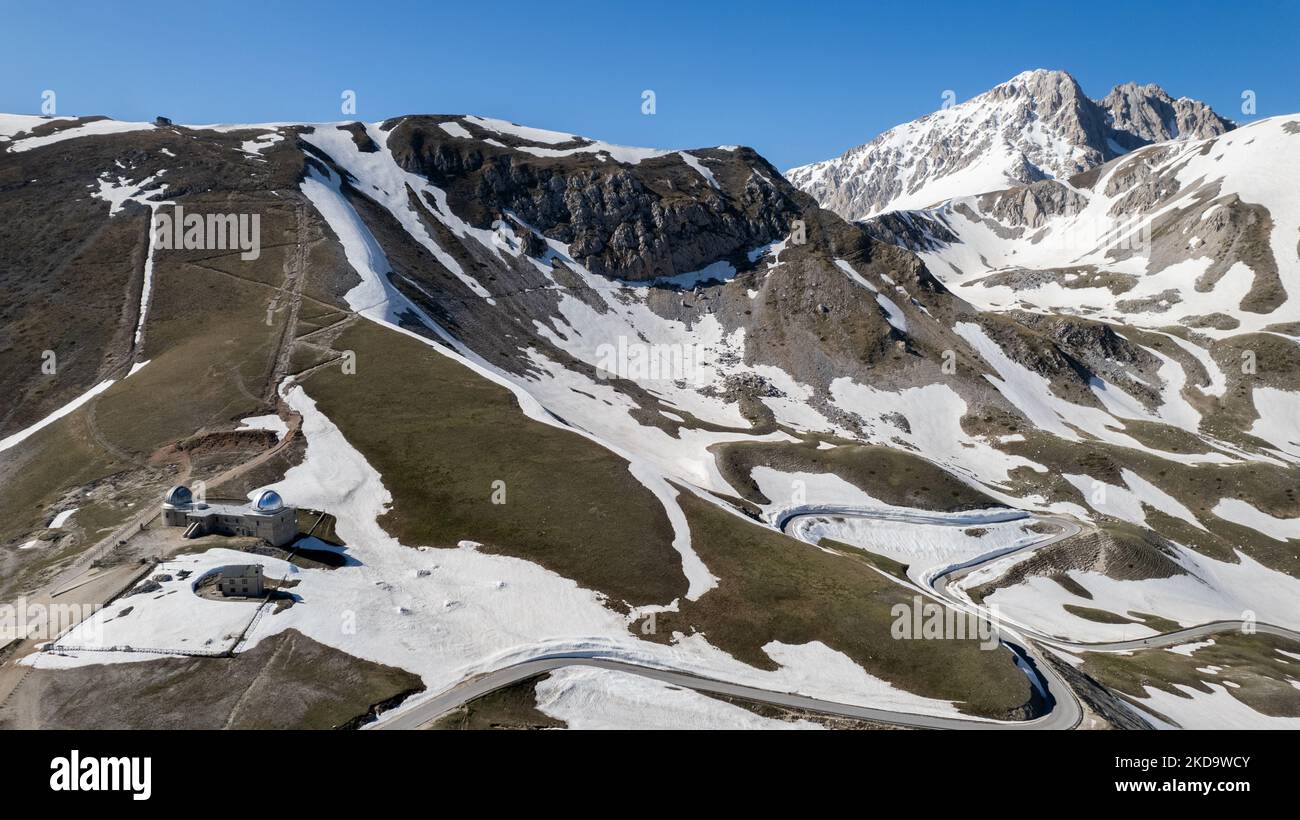 A drone view of Abruzzo Astronomical Observatory at 2.200 m above the sealevel (on the right the Corno Grande) , in Campo Imperatore, Italy, on May 13, 2022. -Gran Sasso d'Italia is a massif in the Apennine Mountains of Italy. Its highest peak, Corno Grande (2,912 metres), is the highest mountain in the Apennines, and the second-highest mountain in Italy outside the Alps. (Photo by Manuel Romano/NurPhoto) Stock Photo