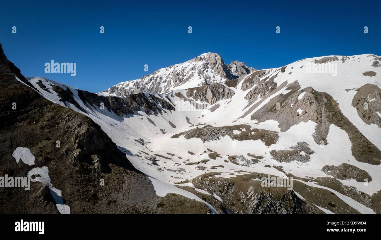 A drone view of the Gran Sasso mountain covered by snow in the Gran Sasso and Laga Mountains National Park, on May 13, 2022. -Gran Sasso d'Italia is a massif in the Apennine Mountains of Italy. Its highest peak, Corno Grande (2,912 metres), is the highest mountain in the Apennines, and the second-highest mountain in Italy outside the Alps. (Photo by Manuel Romano/NurPhoto) Stock Photo