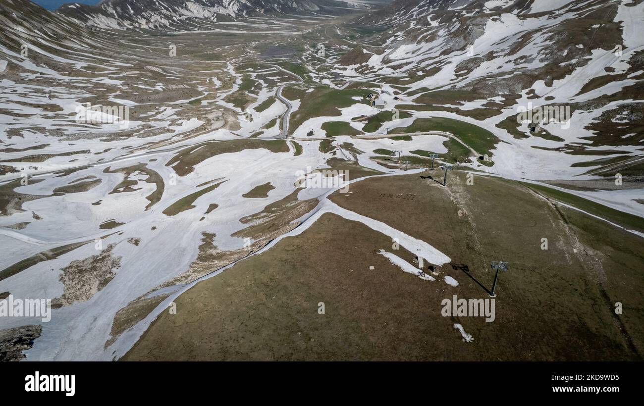 A drone view of plain of Campo Imperatore in the Gran Sasso and Laga Mountains National Park, on May 13, 2022. -Gran Sasso d'Italia is a massif in the Apennine Mountains of Italy. Its highest peak, Corno Grande (2,912 metres), is the highest mountain in the Apennines, and the second-highest mountain in Italy outside the Alps. (Photo by Manuel Romano/NurPhoto) Stock Photo