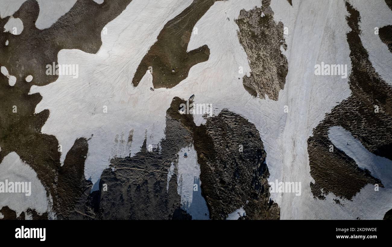 A drone view of a snow in Campo Imperatore in the Gran Sasso and Laga Mountains National Park, on May 13, 2022. -Gran Sasso d'Italia is a massif in the Apennine Mountains of Italy. Its highest peak, Corno Grande (2,912 metres), is the highest mountain in the Apennines, and the second-highest mountain in Italy outside the Alps. (Photo by Manuel Romano/NurPhoto) Stock Photo