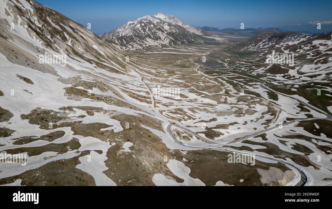 A drone view of the plain of Campo Imperatore, also know as small Tibetin, in the Gran Sasso and Laga Mountains National Park, on May 13, 2022. -Gran Sasso d'Italia is a massif in the Apennine Mountains of Italy. Its highest peak, Corno Grande (2,912 metres), is the highest mountain in the Apennines, and the second-highest mountain in Italy outside the Alps. (Photo by Manuel Romano/NurPhoto) Stock Photo