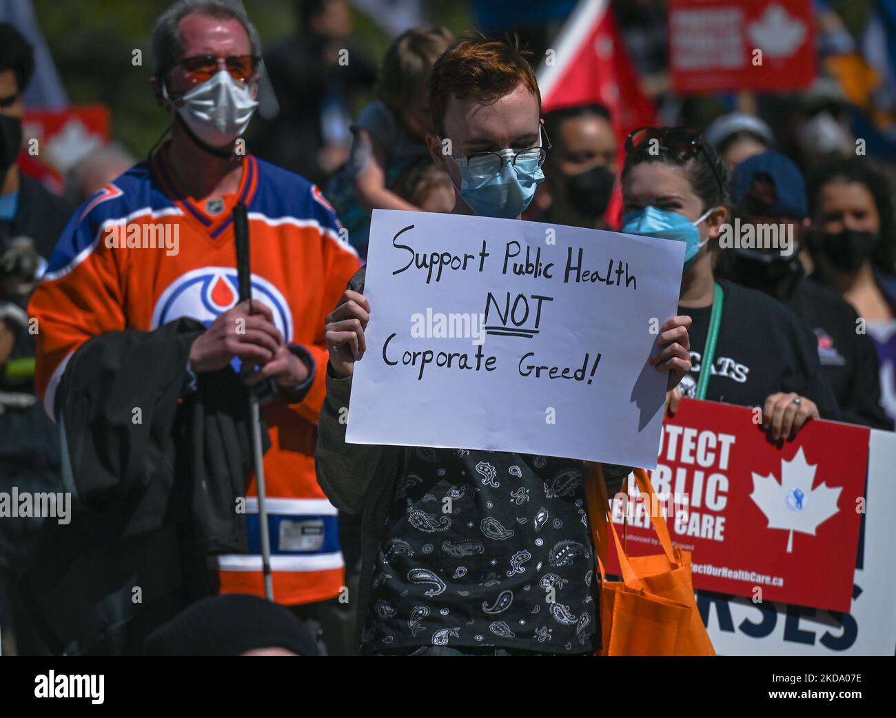 A protester holds a placard with words 'Support Public Health NOT Corporate Greed!'. Health-care workers, activists and their supporters protested this afternoon during 'Rally for Public Health Care' at the Alberta Legislature, in Edmonton, against Premier Kenney and the UCP government that are taking steps to privatize health care. On Saturday, 14 May 2022, in Edmonton, Alberta, Canada. (Photo by Artur Widak/NurPhoto) Stock Photo