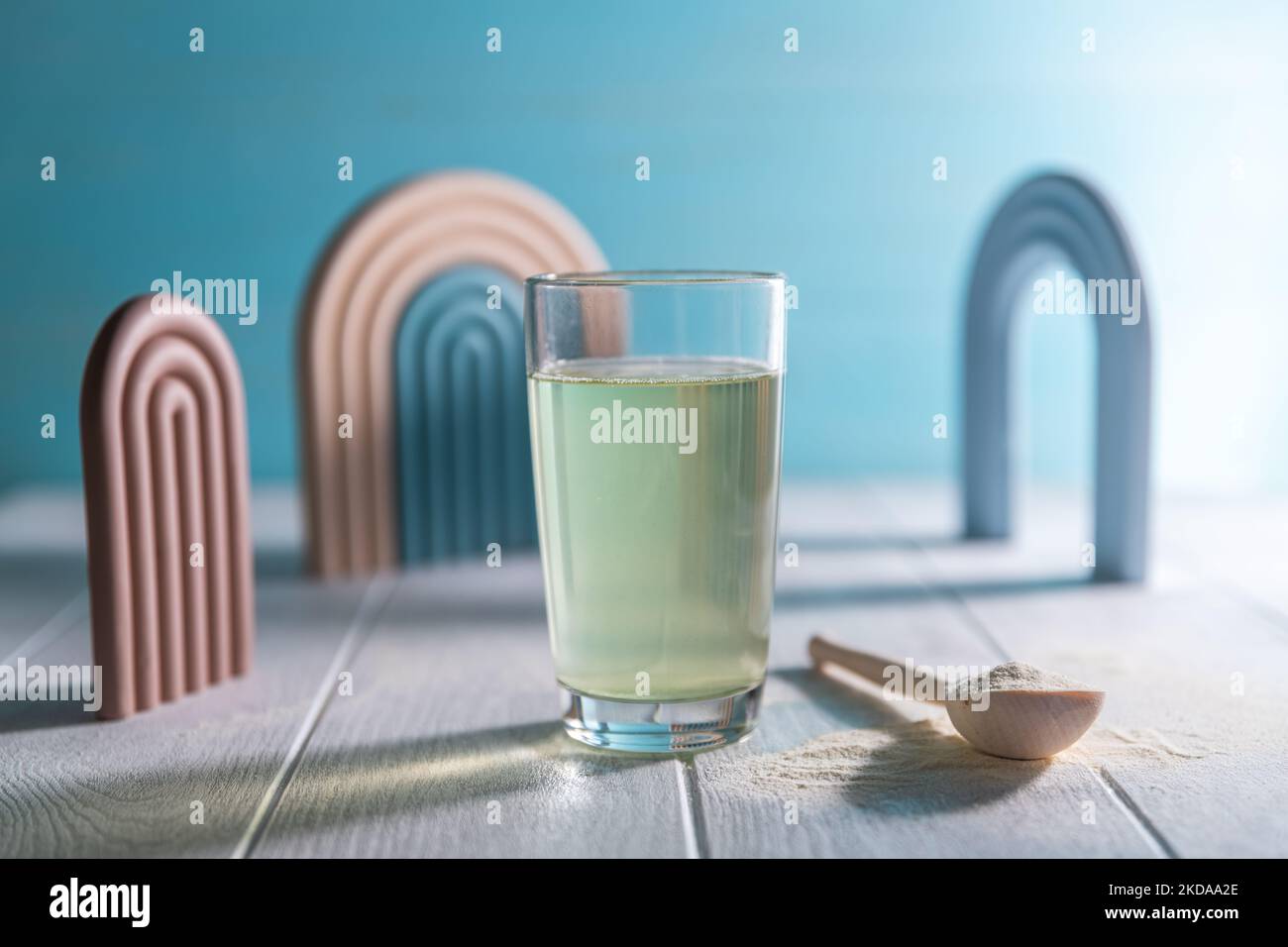 Psyllium husk and glass of water on blue wooden background. Superfood