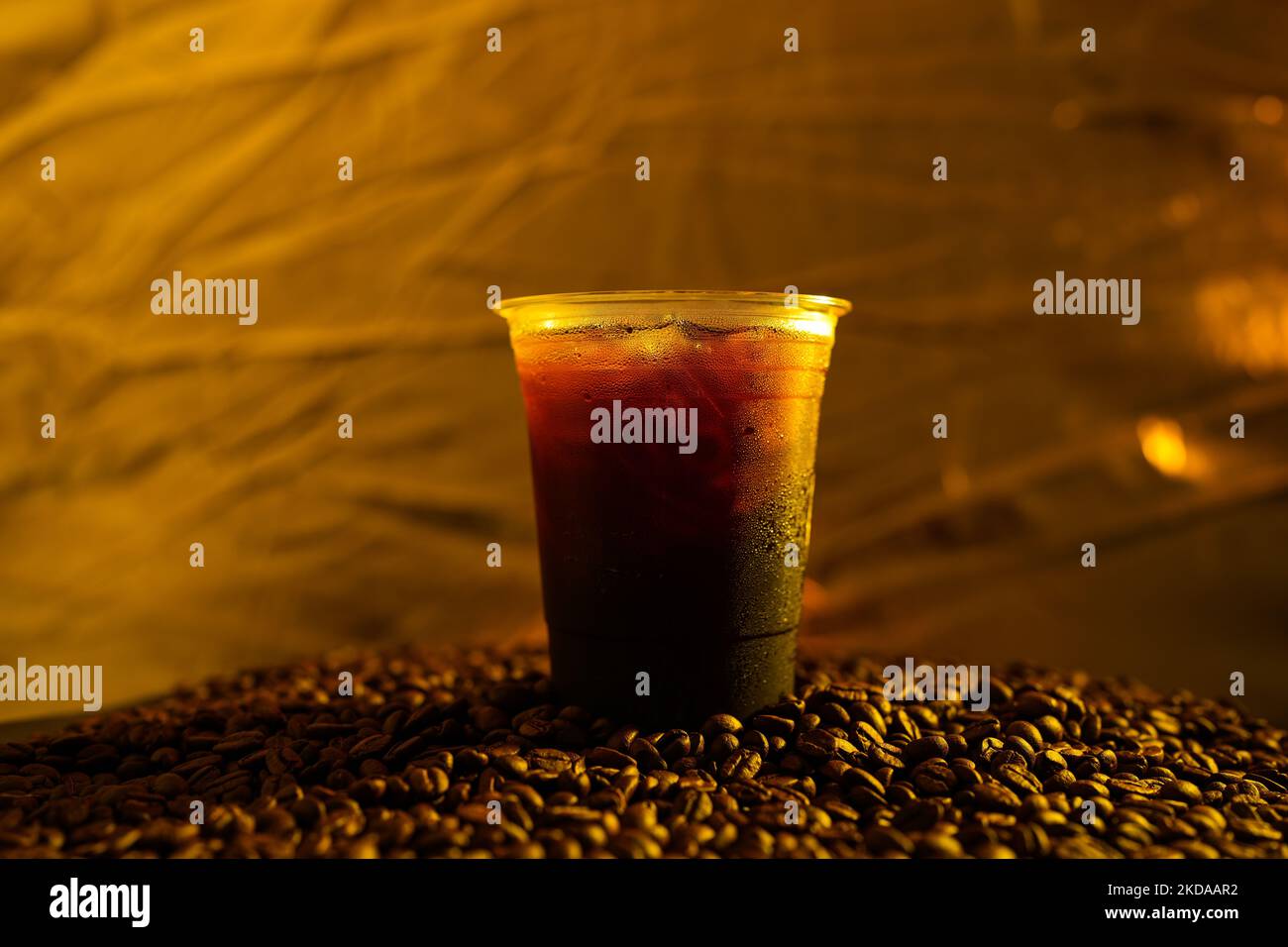 A closeup shot of an Iced Black Coffee in a plastic cup On Roasted ...