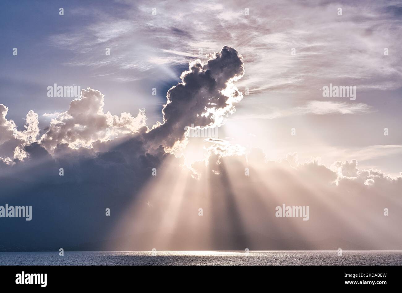 An aerial view of sea under cloudy sky with shining rays Stock Photo ...
