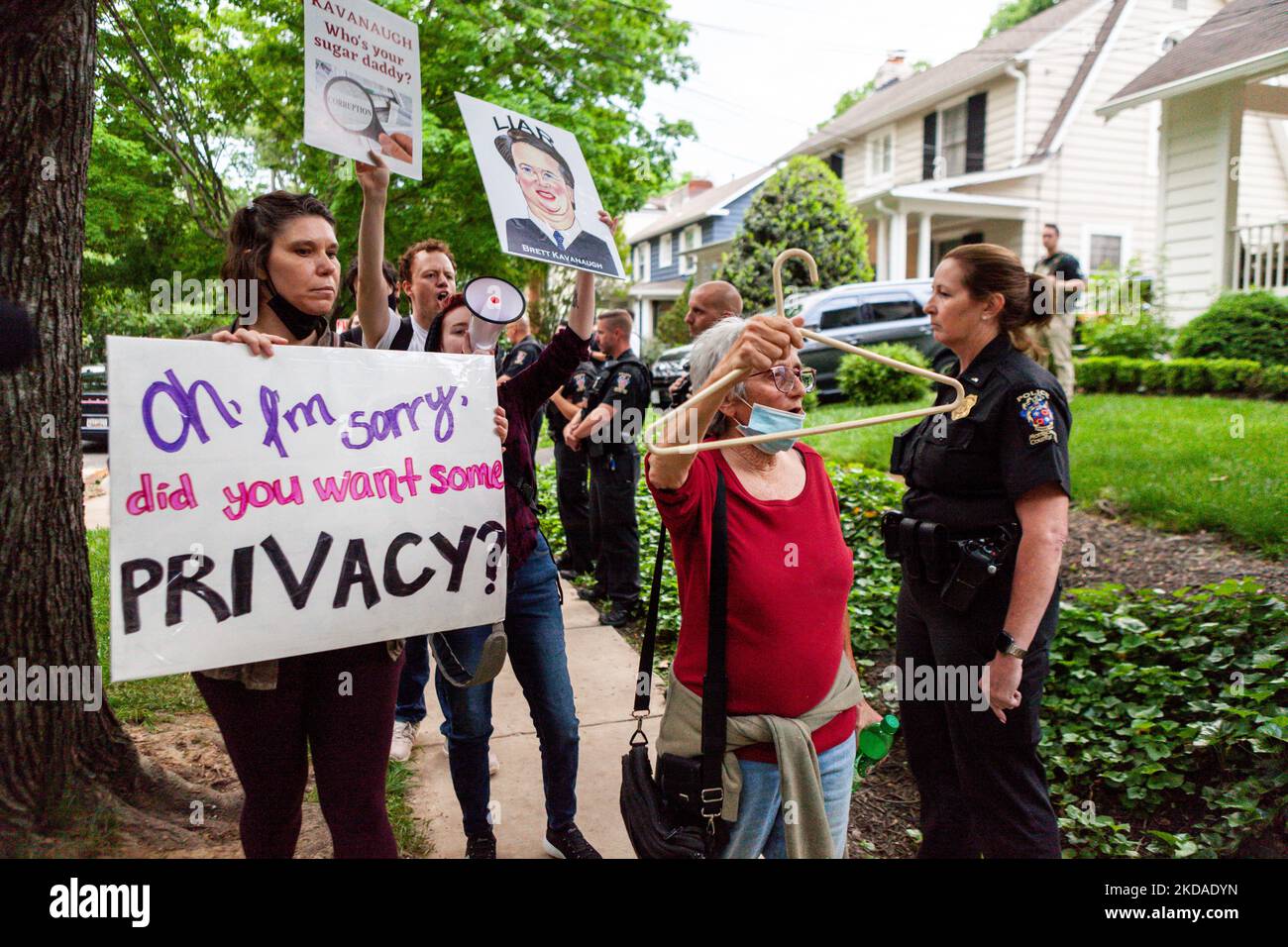 Prochoice protesters walk past police and federal marshals standing in