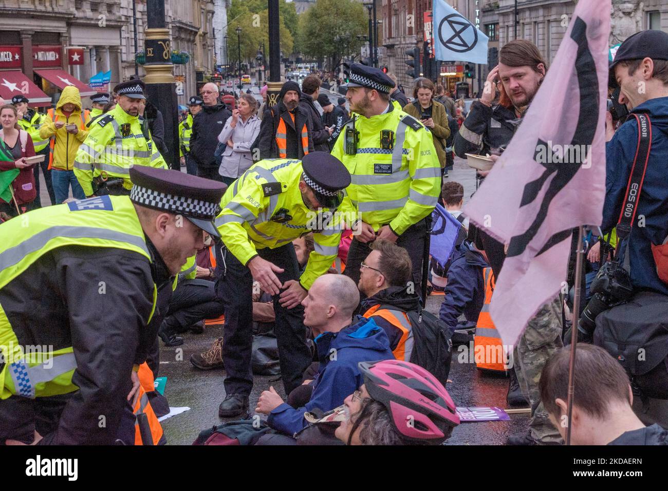 London, UK. 5 Nov 2022. Police tell Stop Oil protesters sitting down at Trafalgar Square after a short march to Piccadilly Circus that they are commiting an offence and may be arrested. After a few minutes they all got up and moved away.  Peter Marshall/Alamy Live News Stock Photo