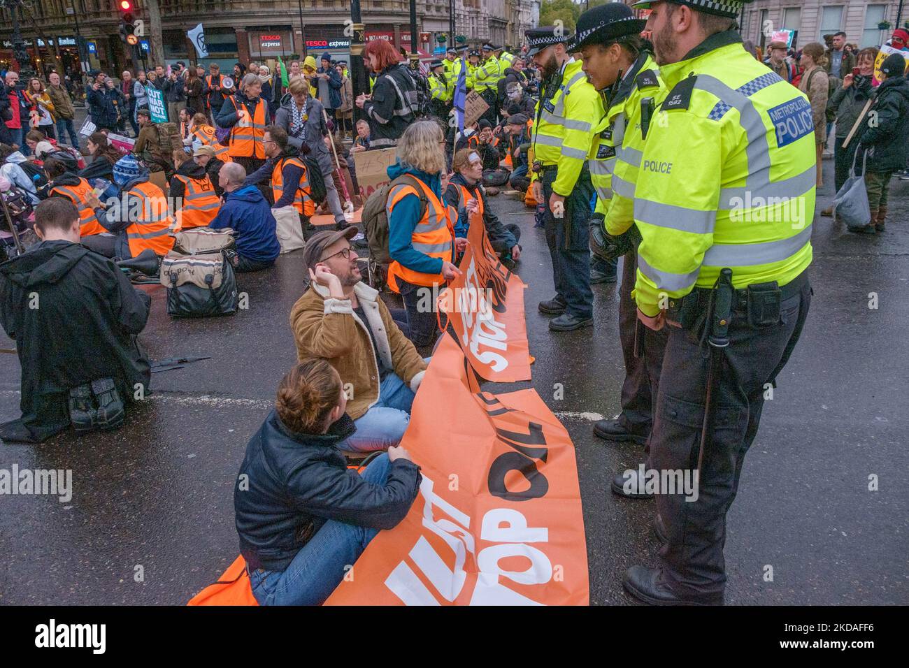 London, UK. 5 Nov 2022. Police tell Stop Oil protesters sitting down at Trafalgar Square after a short march to Piccadilly Circus that they are commiting an offence and may be arrested. After a few minutes they all got up and moved away.  Peter Marshall/Alamy Live News Stock Photo