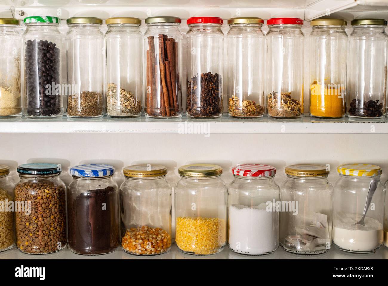 Goiânia, Goias, Brazil – November 05, 2022: Front view of some glass containers with bulk food on a wall shelf. Stock Photo