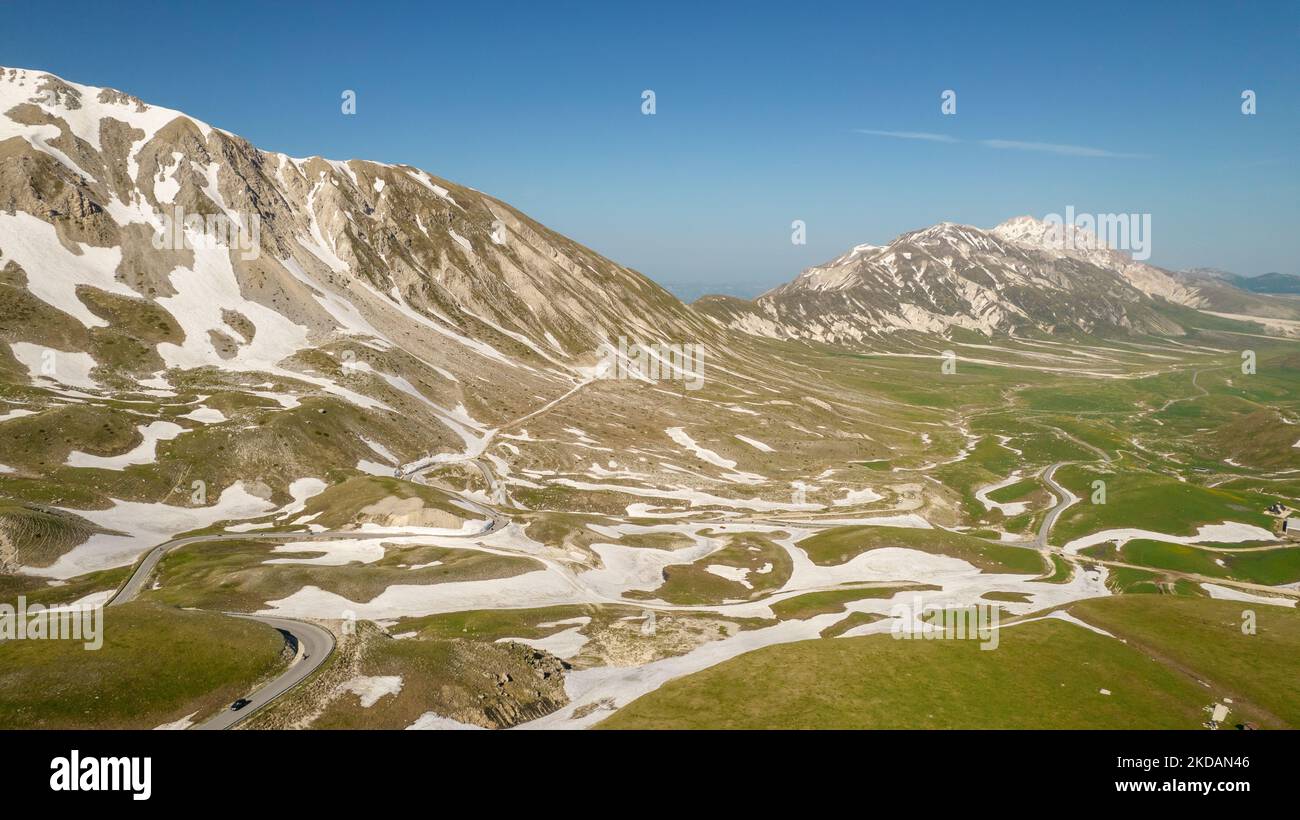 A drone view of the plain of Campo Imperatore, also know as small Tibetin, in the Gran Sasso and Laga Mountains National Park, on May 21, 2022. -Gran Sasso d'Italia is a massif in the Apennine Mountains of Italy. Its highest peak, Corno Grande (2,912 metres), is the highest mountain in the Apennines, and the second-highest mountain in Italy outside the Alps. (Photo by Manuel Romano/NurPhoto) Stock Photo