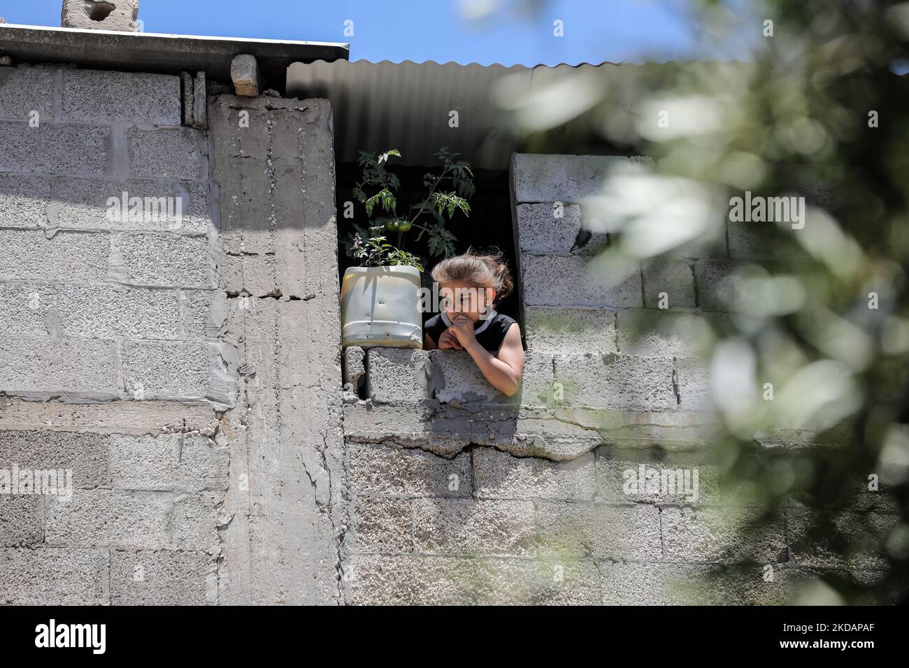 A Palestinian girl looks outside her house in Gaza City,on May 22, 2022 ...