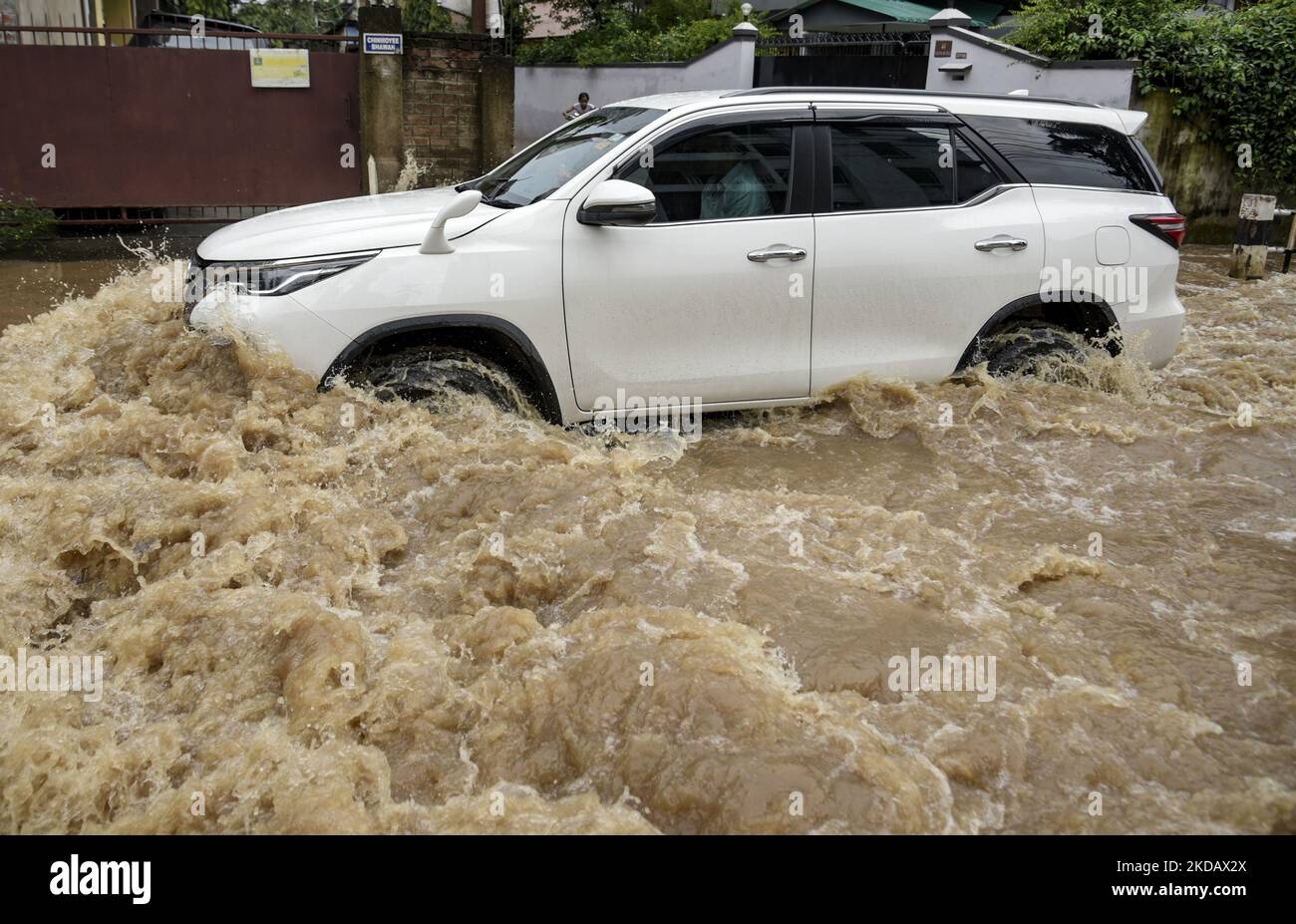 A Car Wades Across A Flooded Street After Heavy Rains In Guwahati 