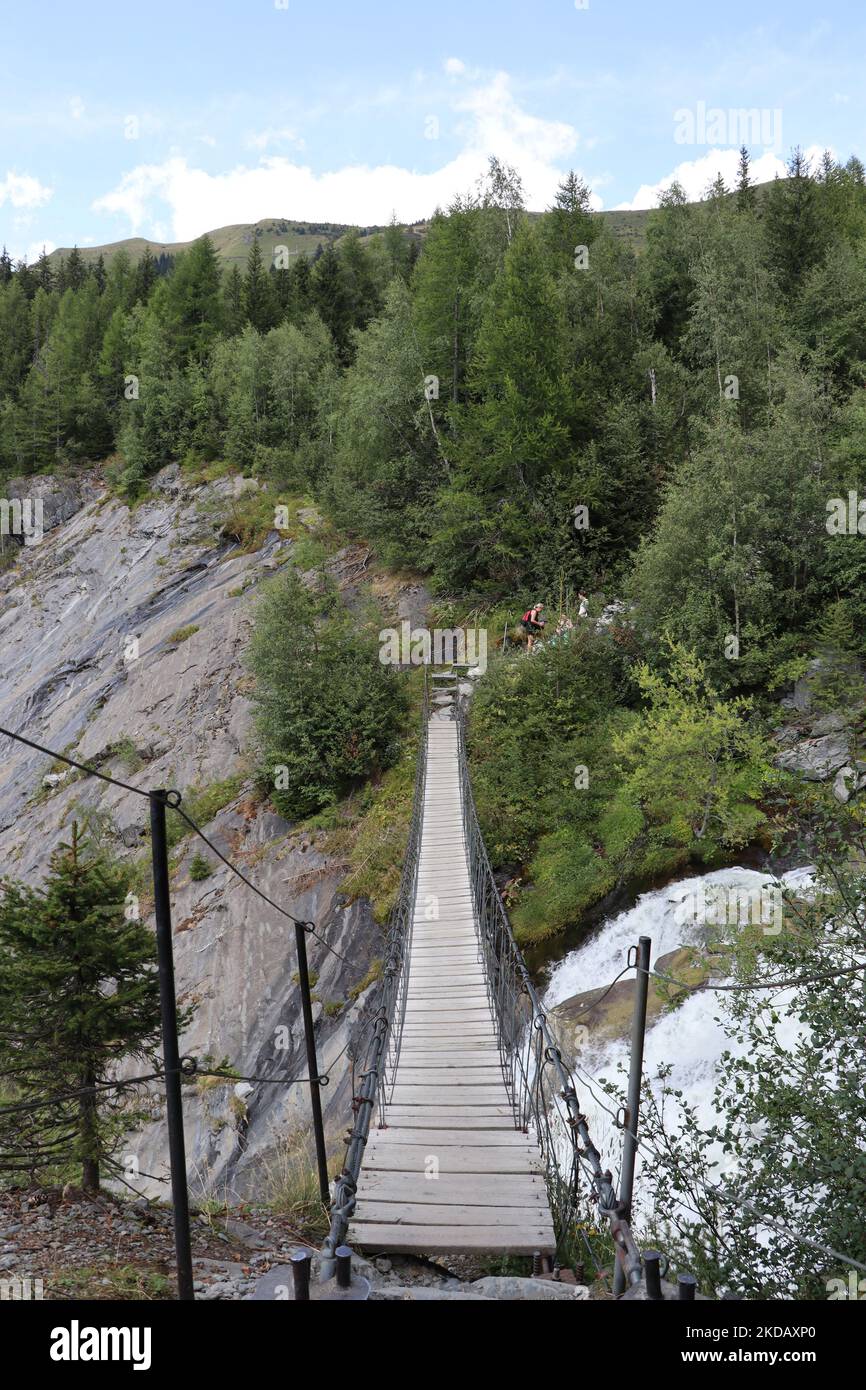A vertical shot of a long rope bridge over a stream in the Mont Blanc Mountains Stock Photo