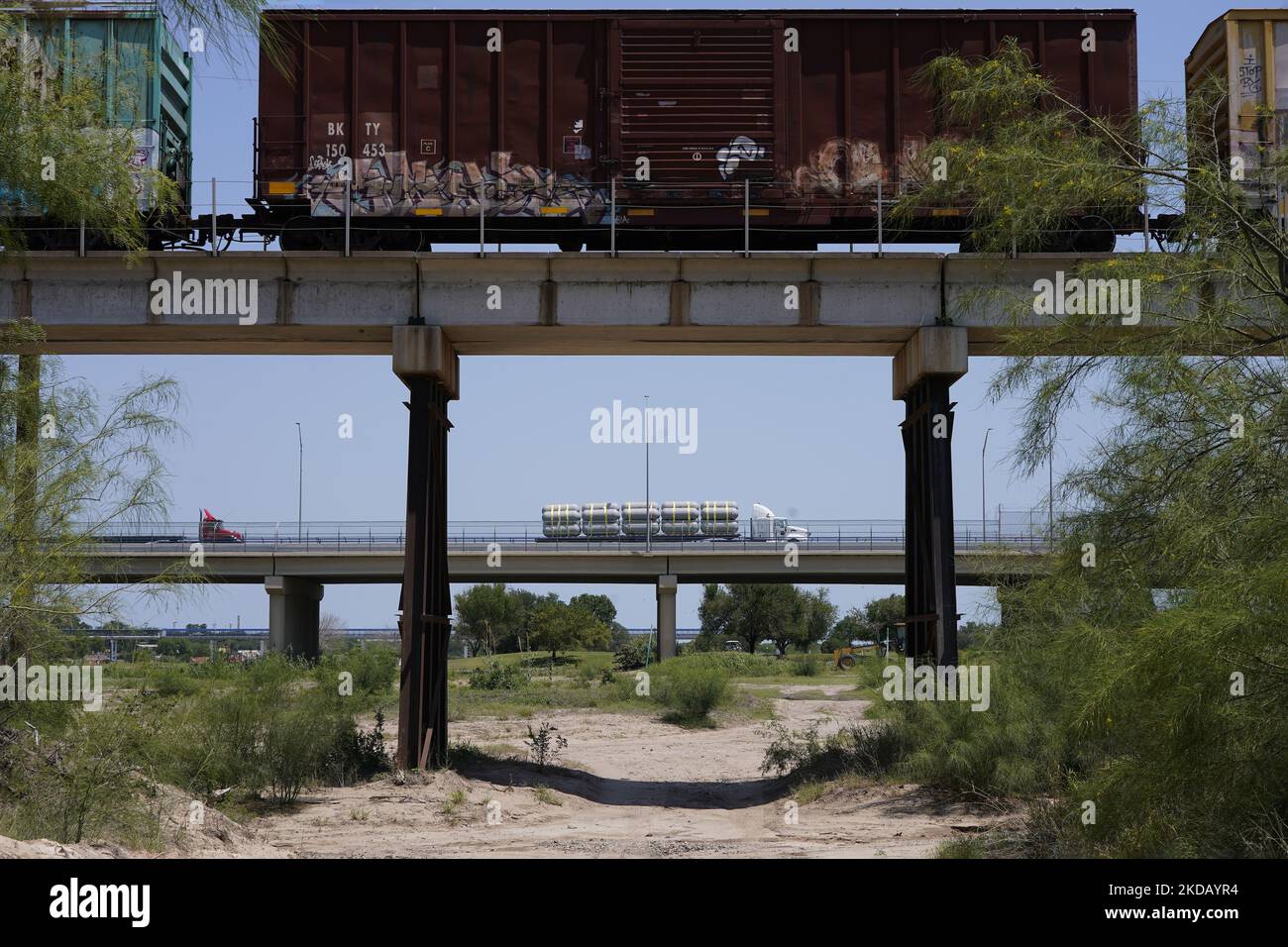 A train and a Truck cross into US from Mexico on May 26 2022 in Eagle Pass Texas, USA. Title 42, the Trump era mandate which was set to prevent migrants from entering the US, was to expire on May 23 but was blocked by a lawsuit filed by several states citing that the move to strike down the law “failed to meet standards set by the Administrative Procedure Act” and that there is no permanent solution to handling the inevitable surge in immigration. Opponents to upholding of the law voiced their demands stating that Title 42 is illegal in that it violates immigration laws that prevents immigrant Stock Photo