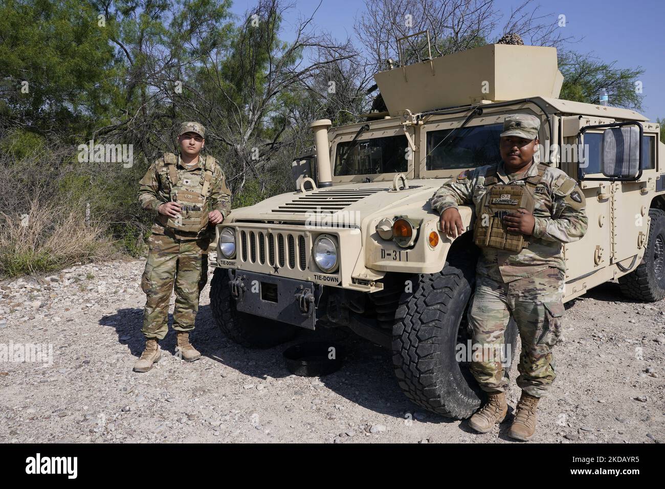 Texas National guardsmen. stand guard along a highway just six miles from the boredr on May 26 2022 near Eagle Pass Texas, USA. Title 42, the Trump era mandate which was set to prevent migrants from entering the US, was to expire on May 23 but was blocked by a lawsuit filed by several states citing that the move to strike down the law “failed to meet standards set by the Administrative Procedure Act” and that there is no permanent solution to handling the inevitable surge in immigration. Opponents to upholding of the law voiced their demands stating that Title 42 is illegal in that it violates Stock Photo