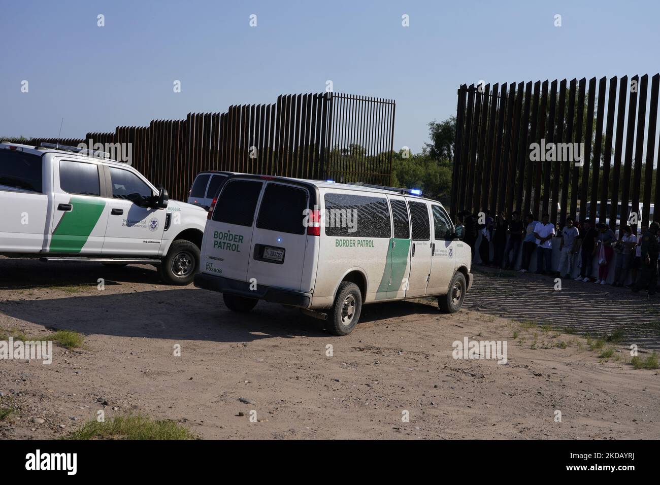 Border Patrol vehicles are seen by the Border Wall on May 26 2022 in Eagle Pass Texas, USA. Title 42, the Trump era mandate which was set to prevent migrants from entering the US, was to expire on May 23 but was blocked by a lawsuit filed by several states citing that the move to strike down the law “failed to meet standards set by the Administrative Procedure Act” and that there is no permanent solution to handling the inevitable surge in immigration. Opponents to upholding of the law voiced their demands stating that Title 42 is illegal in that it violates immigration laws that prevents immi Stock Photo