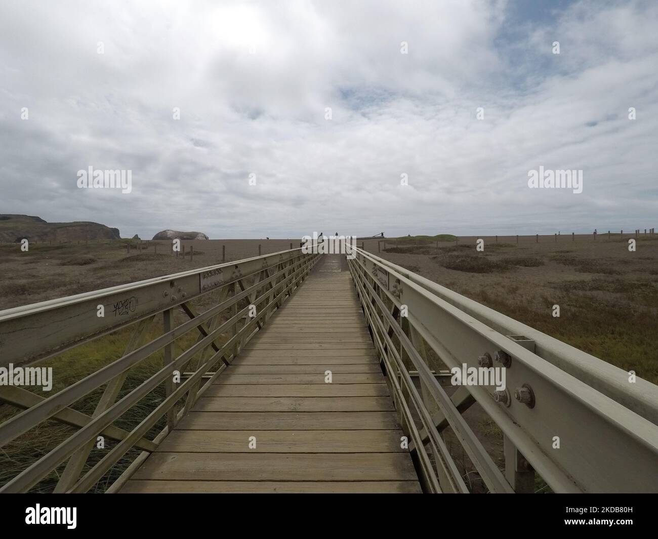 An empty wooden bridge on a gloomy day under the cloudy sky Stock Photo ...