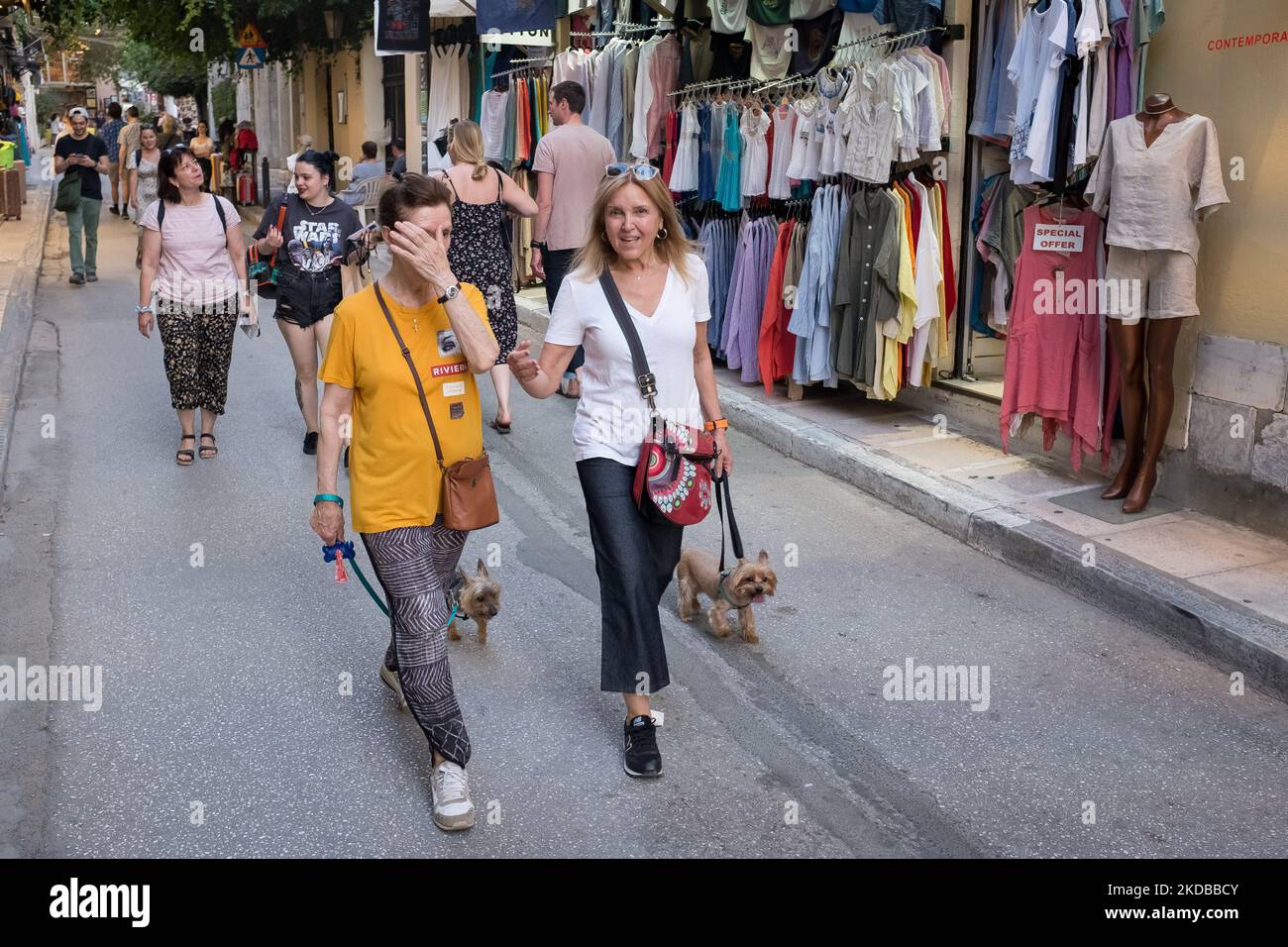 Two women with their dogs are walking in the center if Athens, Greece on June 1, 2022. Greece was in high temperatures today. (Photo by Nikolas Kokovlis/NurPhoto) Stock Photo