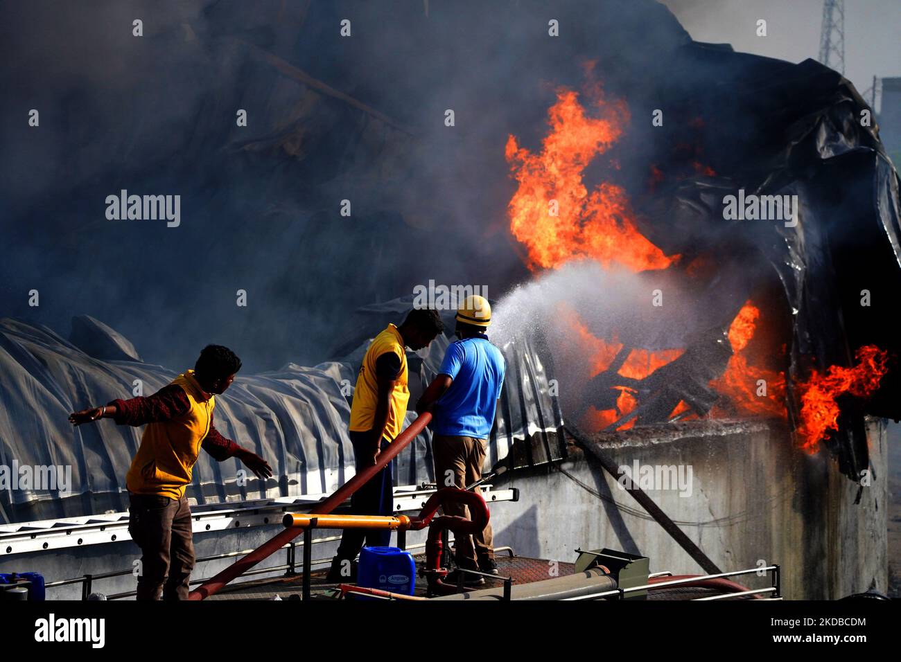 Indian Fire fighters attempt to douse flames after a fire broke out in ...