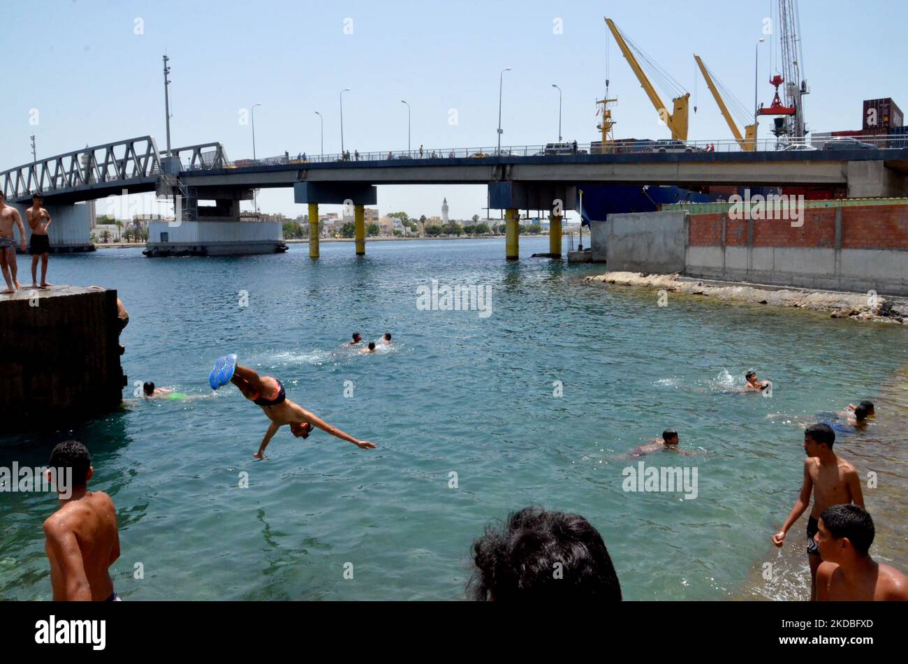 A group of young people enjoying the sea in very hot weather in the city of Bizerte near the port in Tunis,Tunisia on Jun 04,2022. (Photo by Yassine Mahjoub/NurPhoto) Stock Photo