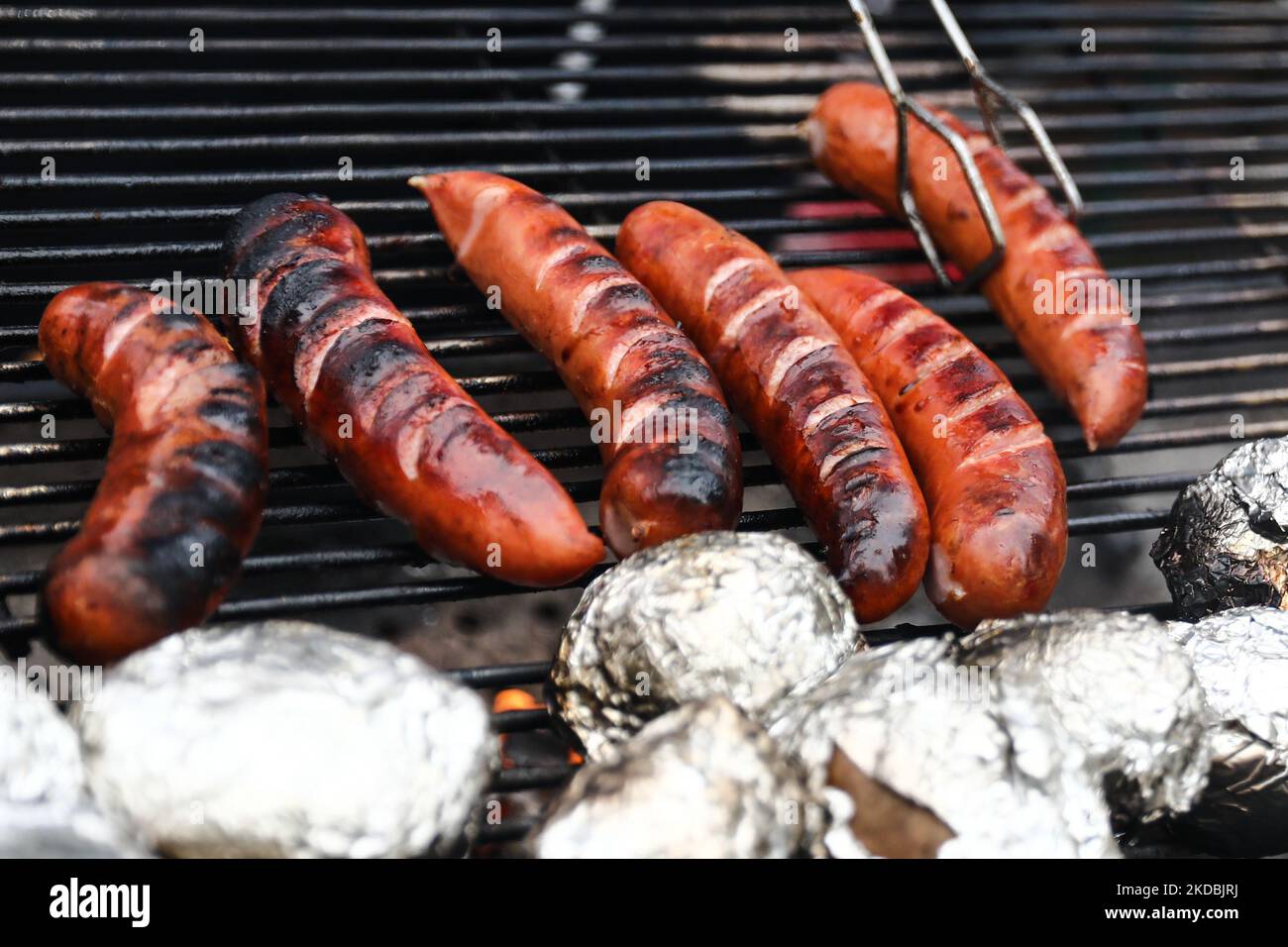 Sausages are seen preparing on a grill in Dobczyce, Poland on June 4, 2022. (Photo by Jakub Porzycki/NurPhoto) Stock Photo