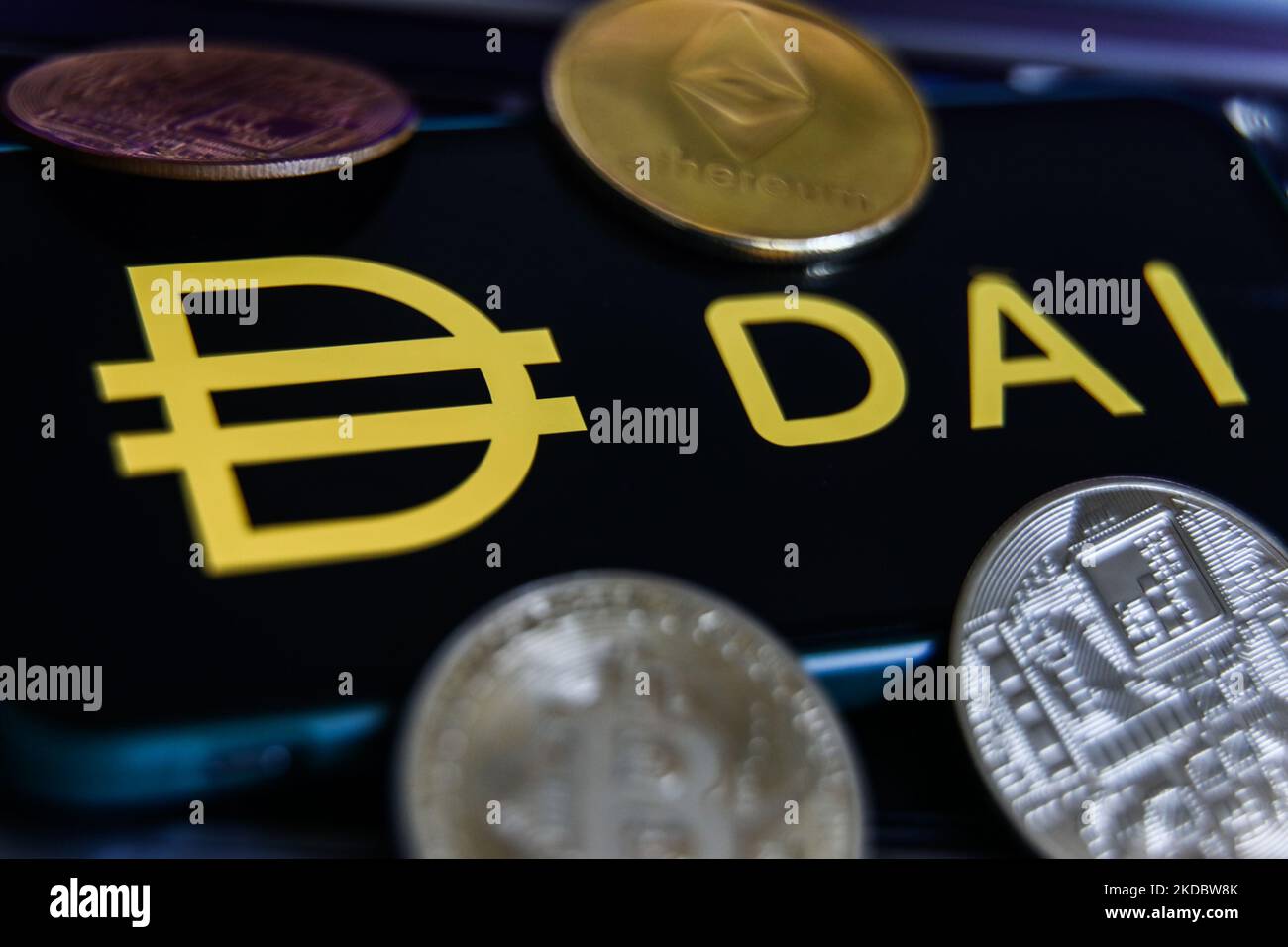 Dai logo displayed on a phone screen and representation of cryptocurrencies are seen in this illustration photo taken in Krakow, Poland on June 10, 2022. (Photo by Jakub Porzycki/NurPhoto) Stock Photo