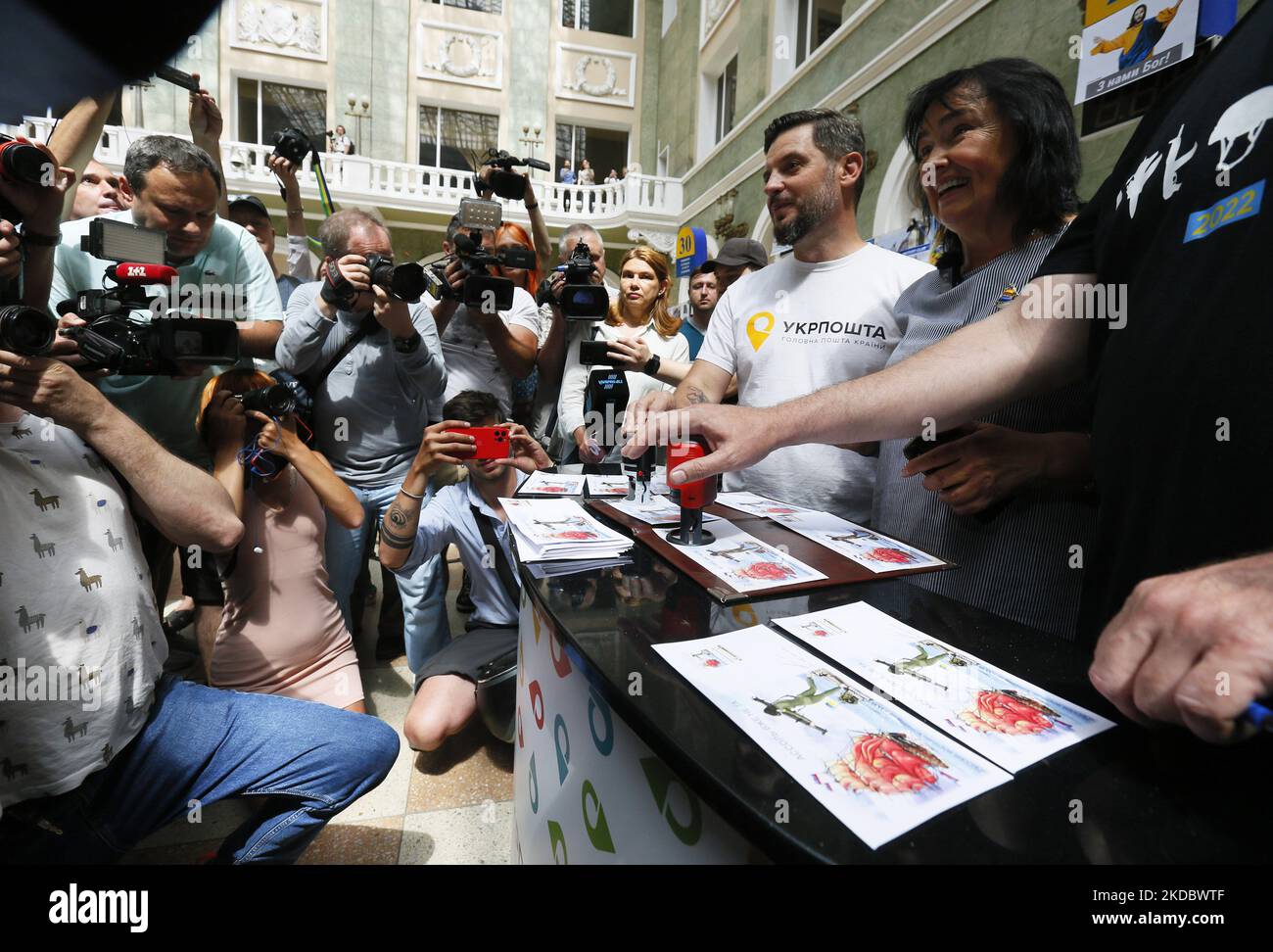 People look on cancellation of a new set of commemorative postal service stamps dedicated to the Ukrainian resistance, amid Russia's invasion of Ukraine, at main postal office in Odesa, Ukraine 10 June 2022. The new set of postal stamps ''Assol is no the same anymore'' is a like unofficial sequel of set of Ukraine's postage stamps 'Russian warship - Done!'. The postage stamps are issued by a private initiative in a limited edition in 400 pieces and has traditionally caused a stir among Ukrainians, as local media informed. The collected funds from the sale of the new postage marks will be used  Stock Photo