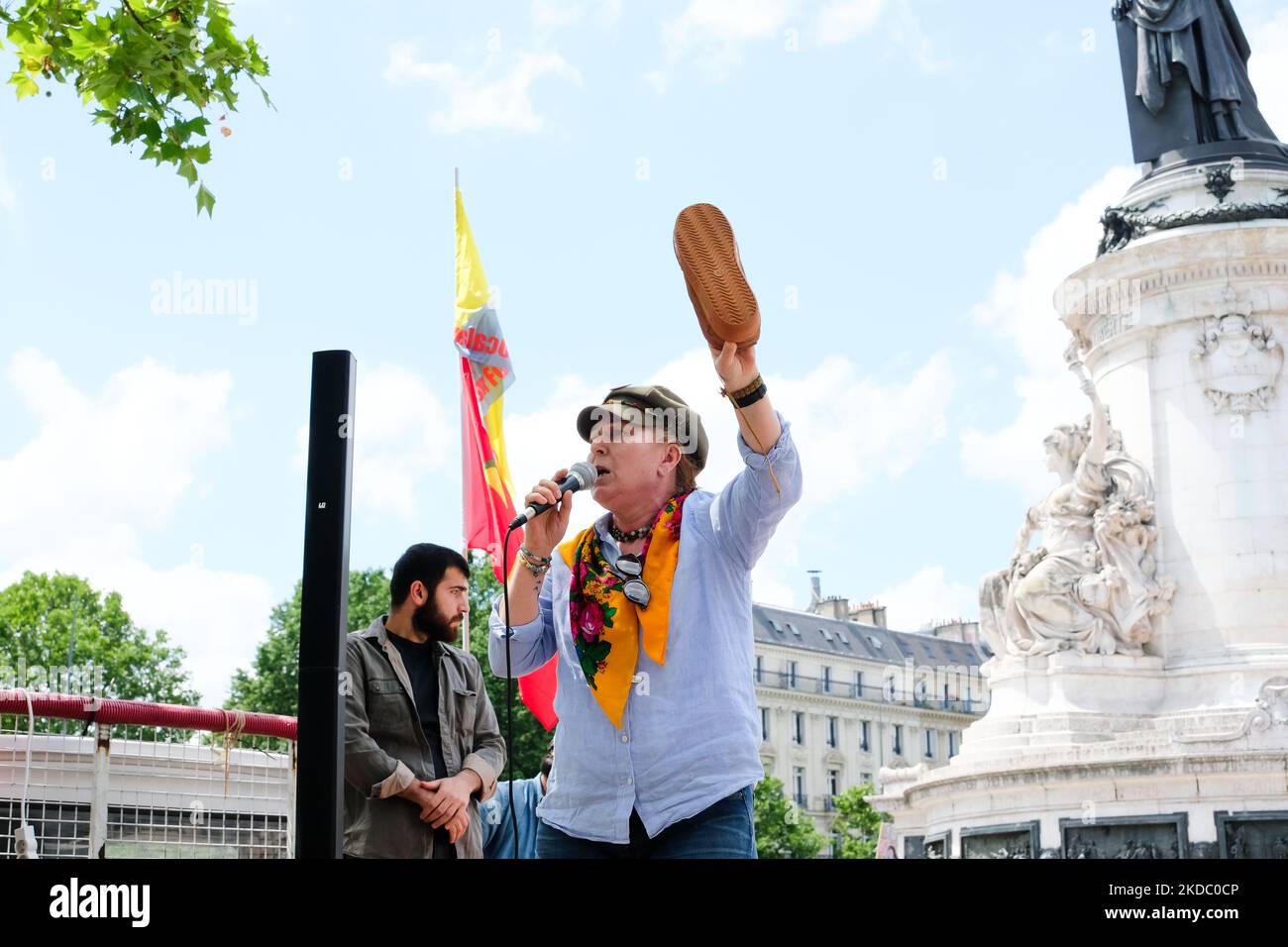 Berivan Firat, spokesman for the Kurdish Democratic Council in France, holds in his hands a shoe of the Kurdish guerrillas of the PKK, in Paris, France, on June 11, 2022. (Photo by Vincent Koebel/NurPhoto) Stock Photo