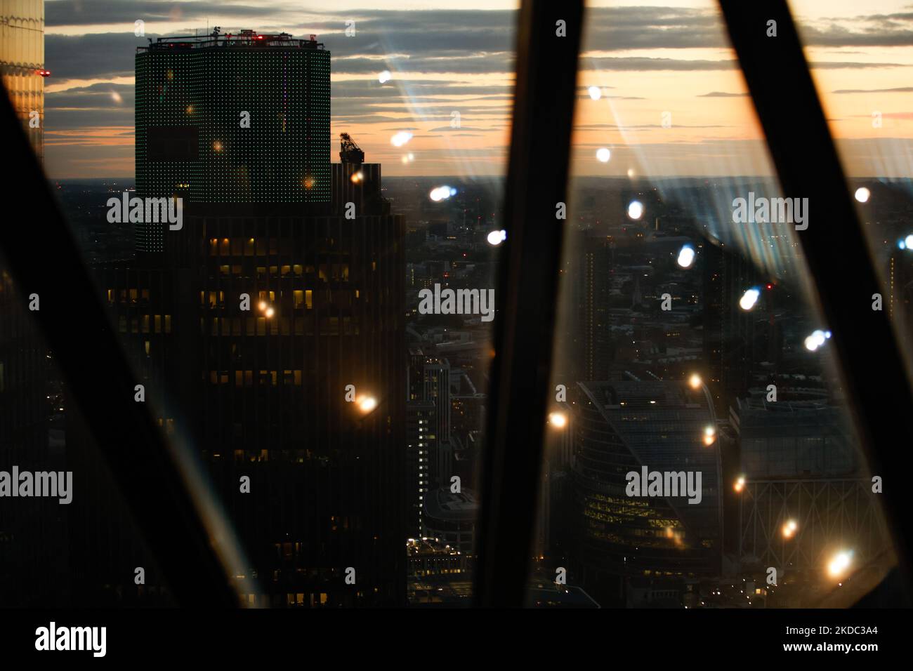 The Tower 42 skyscraper stands in the City of London financial district, seen through windows at the top of the 30 St Mary Axe tower, commonly known as The Gherkin, at sunset in London, England, on June 12, 2022. (Photo by David Cliff/NurPhoto) Stock Photo