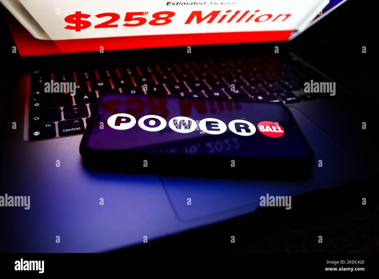 Powerball logo displayed on a phone screen and Powerball website