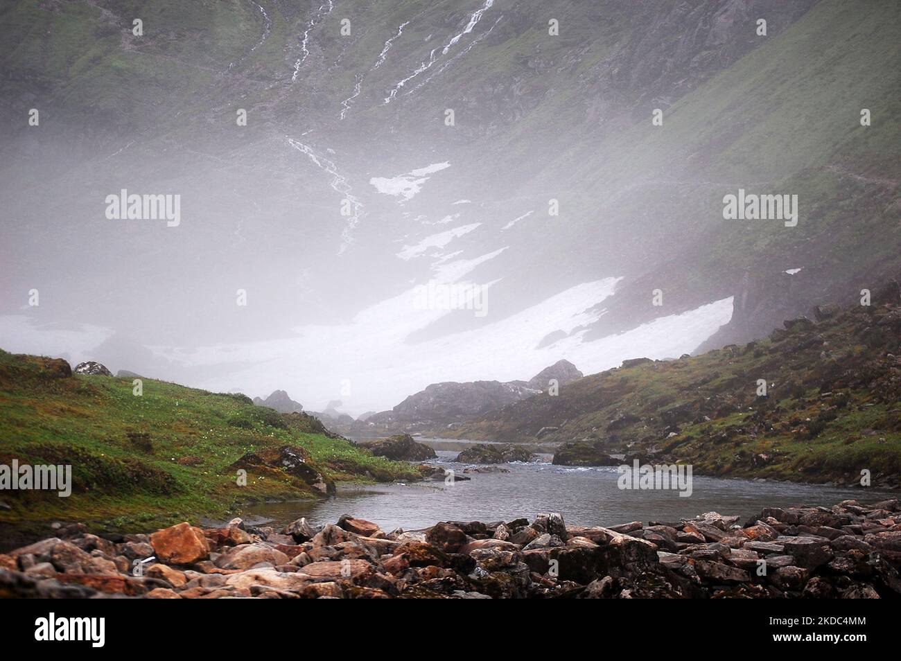 River Surrounded By Rocks A landscape view of the river surrounded by rocks and mountains Stock ...