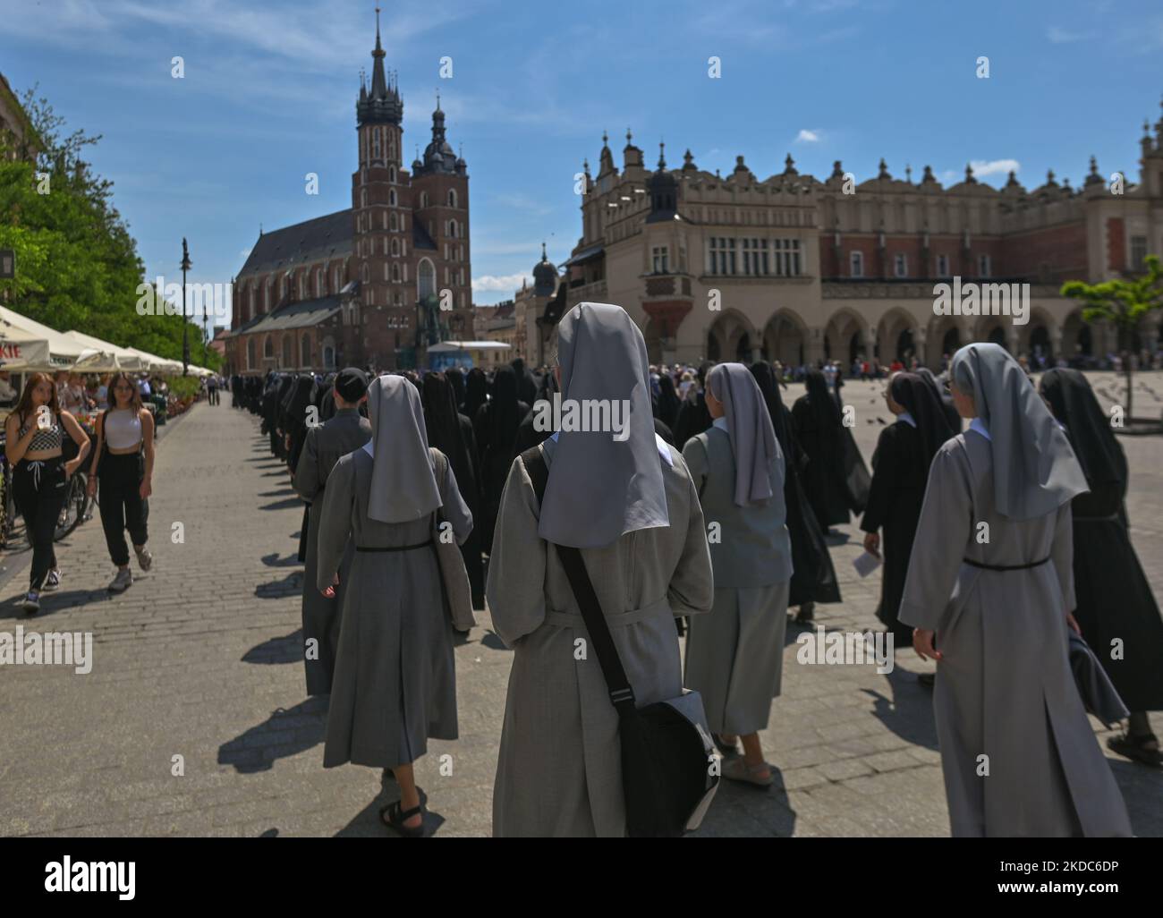 Members of local female religious congregations marching during the