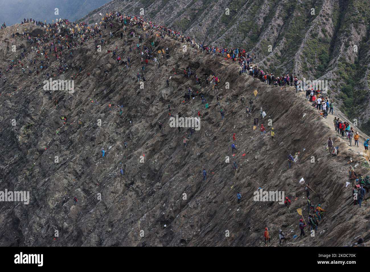 Tenggerese gather during the Yadnya Kasada Festival at the crater of Mount Bromo on June 16, 2022 in Probolinggo, East Java Province, Indonesia. Villagers and worshippers throw offerings such as livestock and other crops into the volcanic crater of Mount Bromo to give thanks to the Hindu gods for ensuring their safety and prosperity. (Photo by Garry Lotulung/NurPhoto) Stock Photo