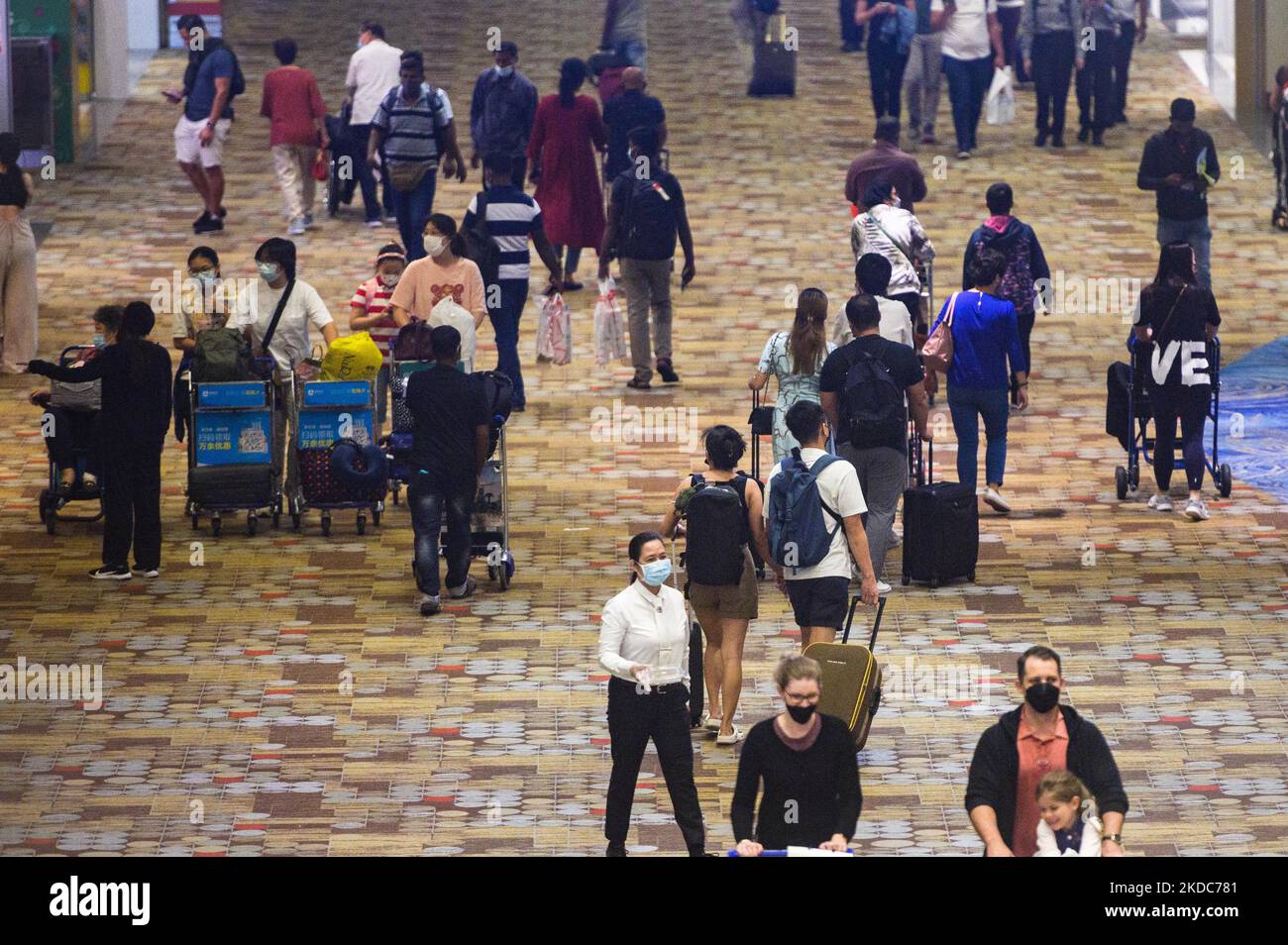 Travellers wearing mandatory protective masks in the transit area of