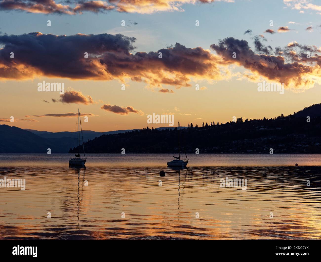 The boats in the sea during scenic sunset Stock Photo - Alamy