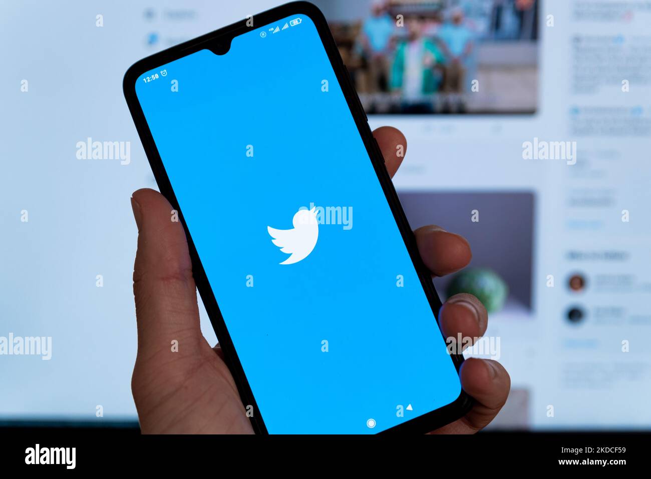 In this photo illustration the Twitter logo is seen on the screen of a mobile phone. The social network was acquired by the entrepreneur Elon Musk for a record breaking sum of 44 billion dollars. Stock Photo