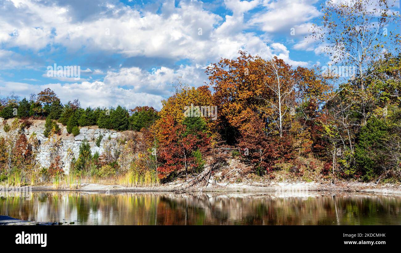 Landscape with lake reflecting cloudy sky and rock bluffs at Klondike